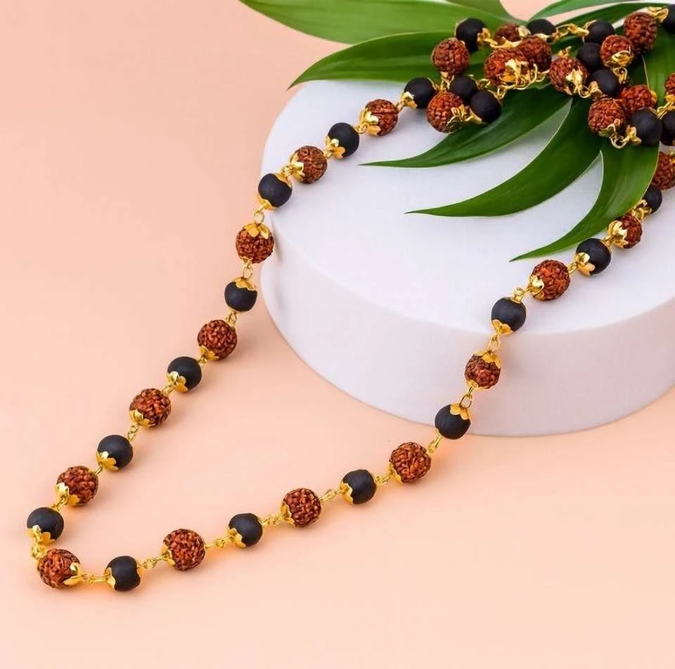 Gold plated mala chain features alternating red Rudraksha and black crystal beads