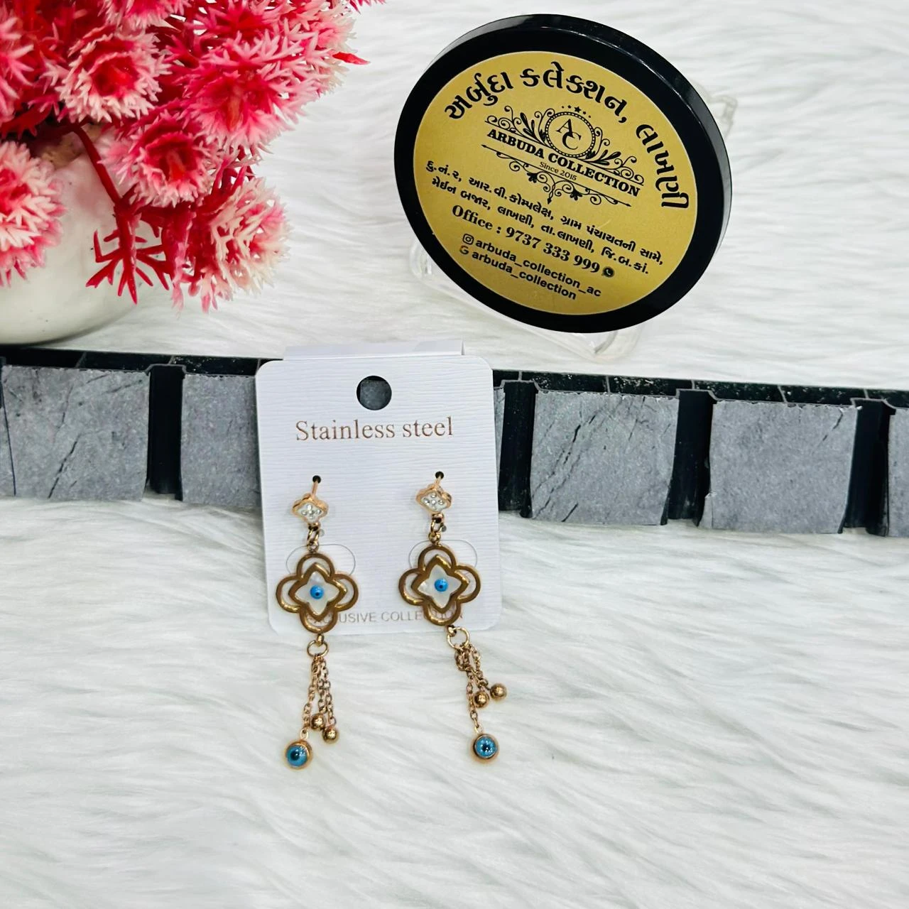 Rose gold-toned, stainless steel flower and evil eye drop earrings.