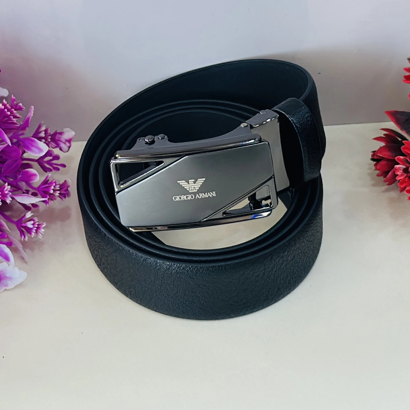 Giorgio Armani black leather ratchet belt with a metal logo buckle.