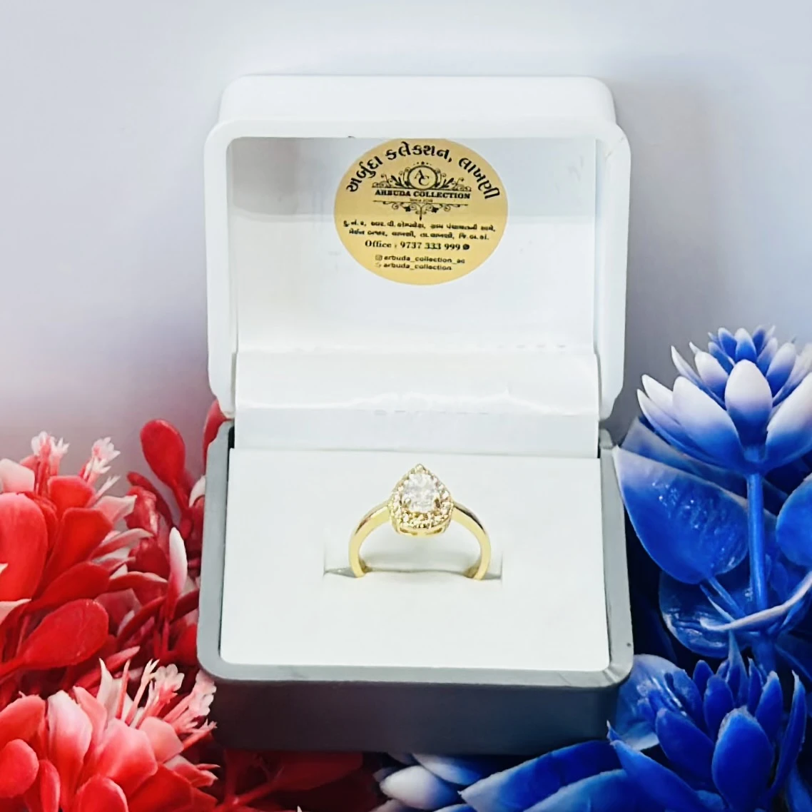Yellow gold pear-shaped diamond halo ring.