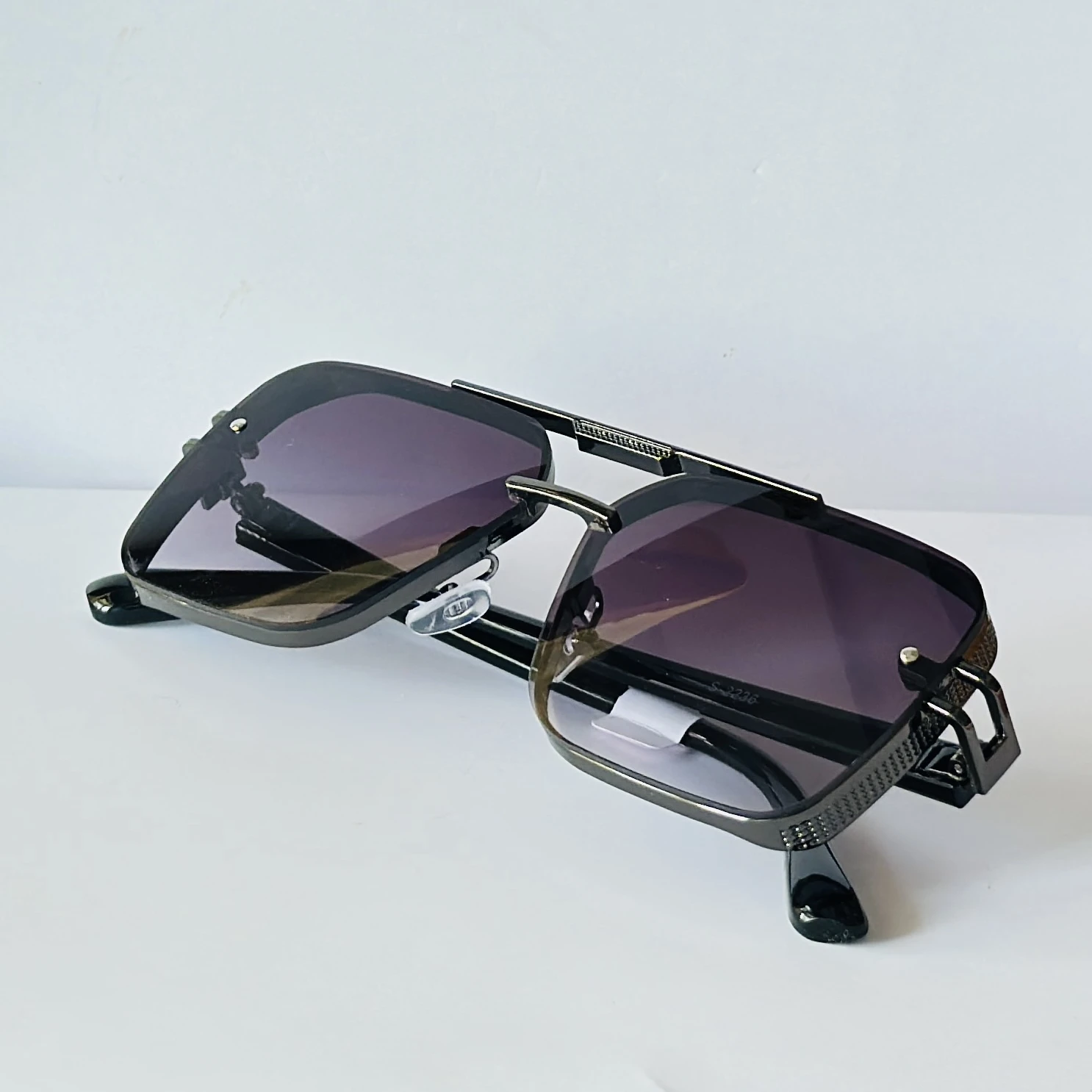 appear to be retro square or modern pilot-style sunglasses for men