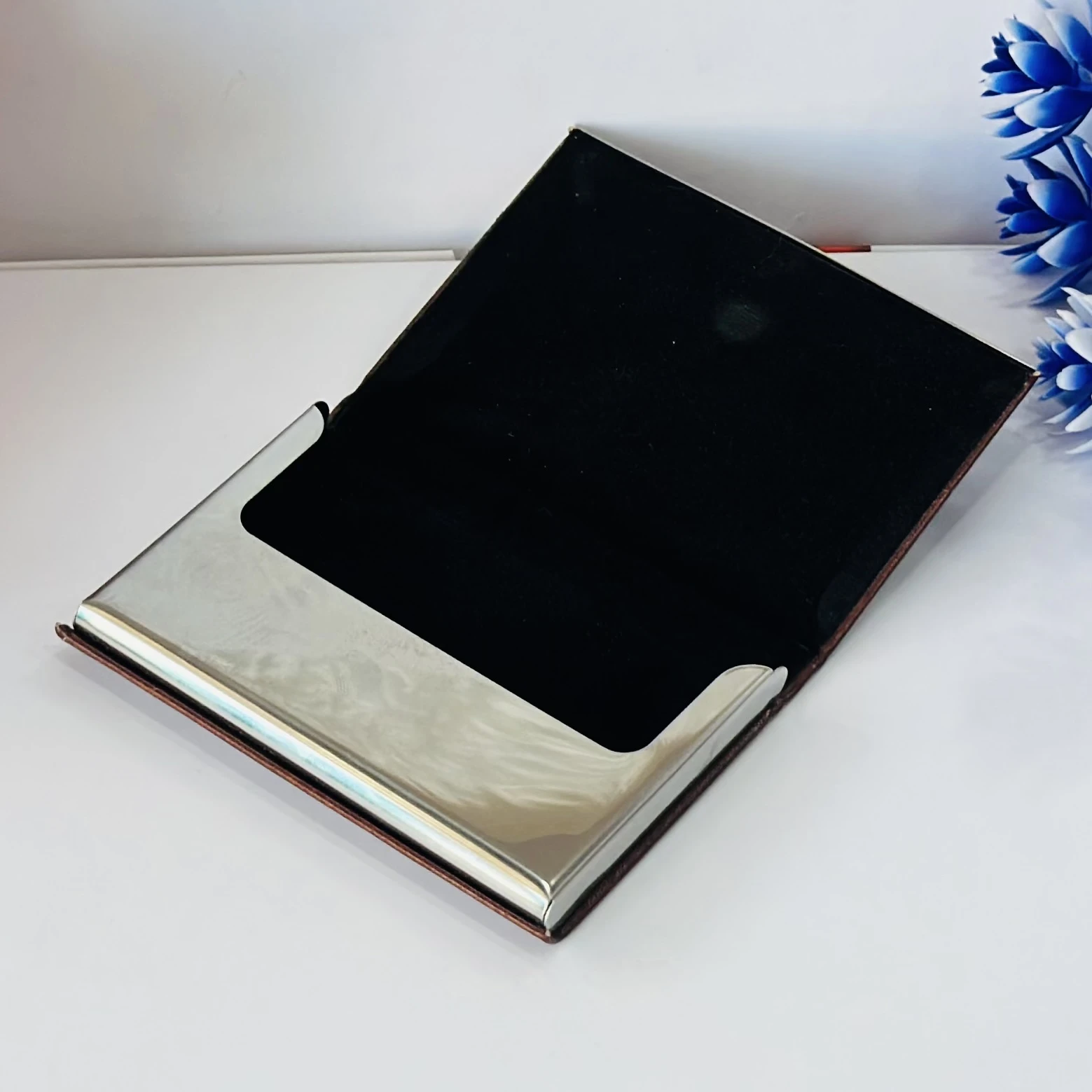 business card holder or card case, likely made of PU leather and stainless steel.