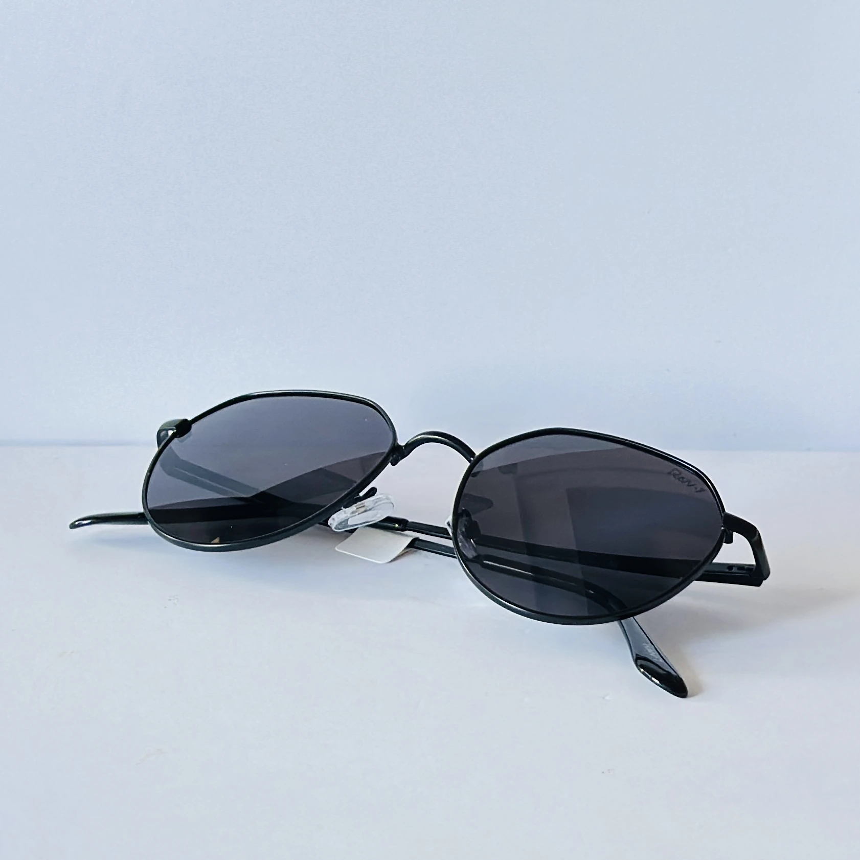 Ray-Ban style hexagonal sunglasses with a black metal frame.