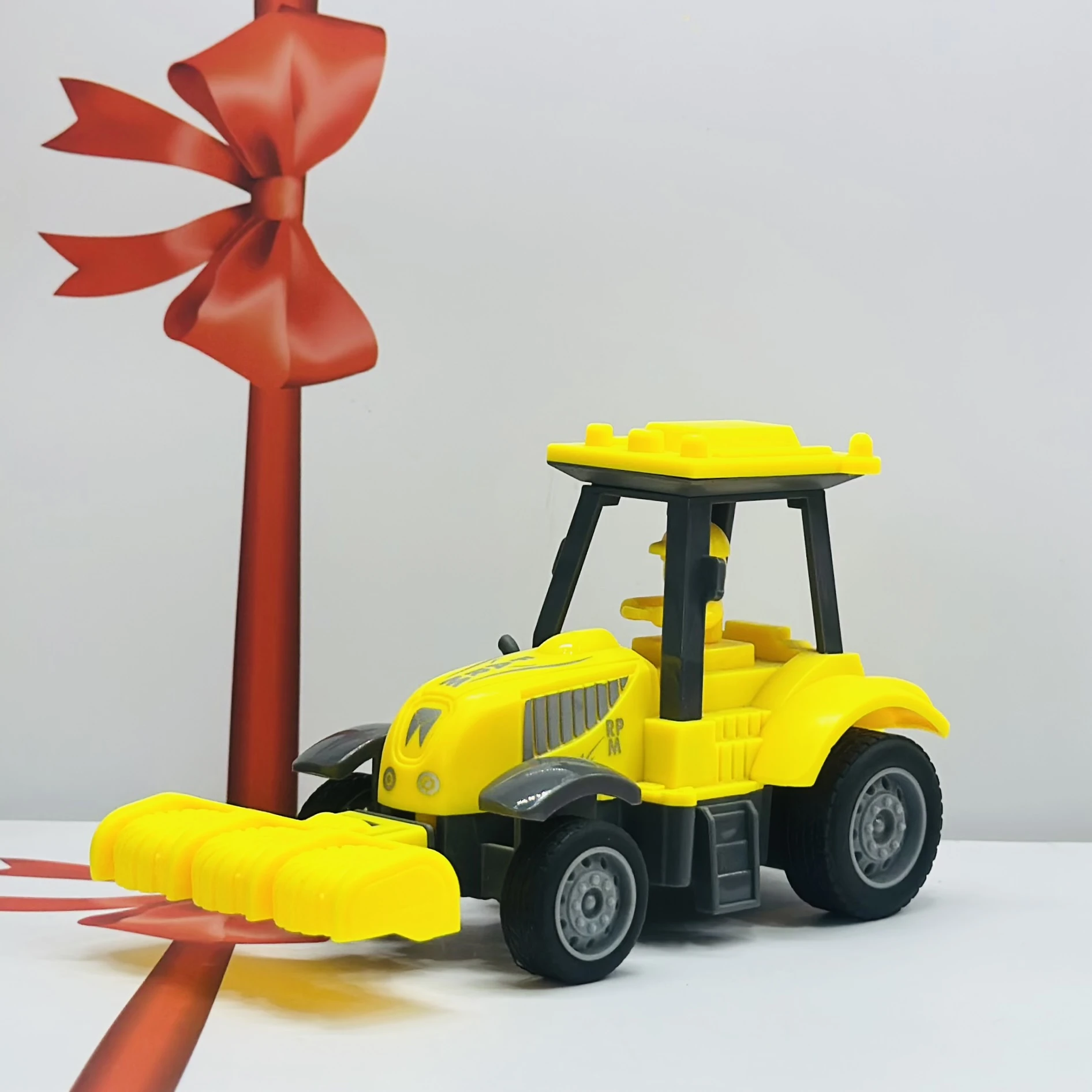Yellow plastic toy tractor