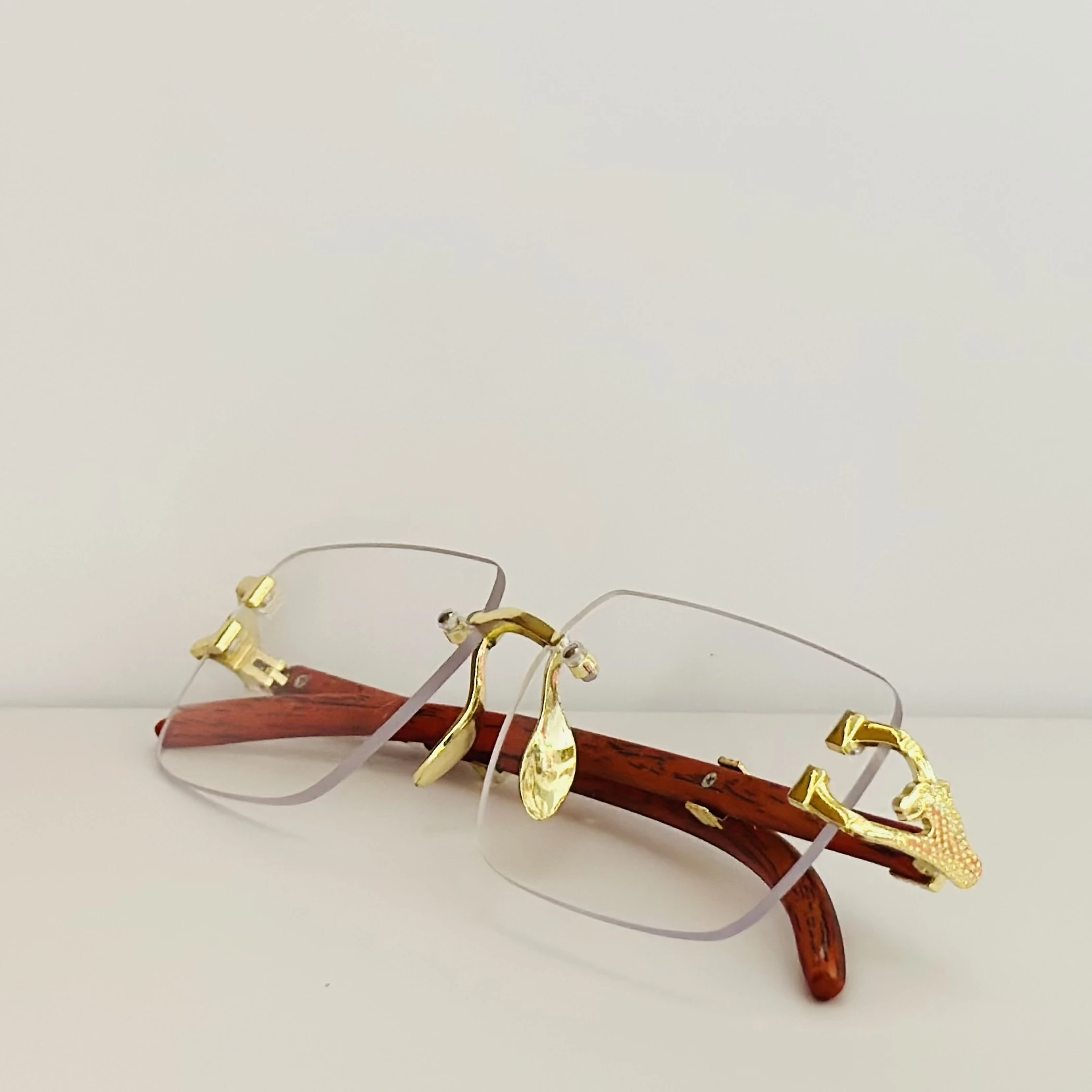 Street Knitted men's rimless gold frame glasses with clear lenses and a woodgrain finish on the arms.