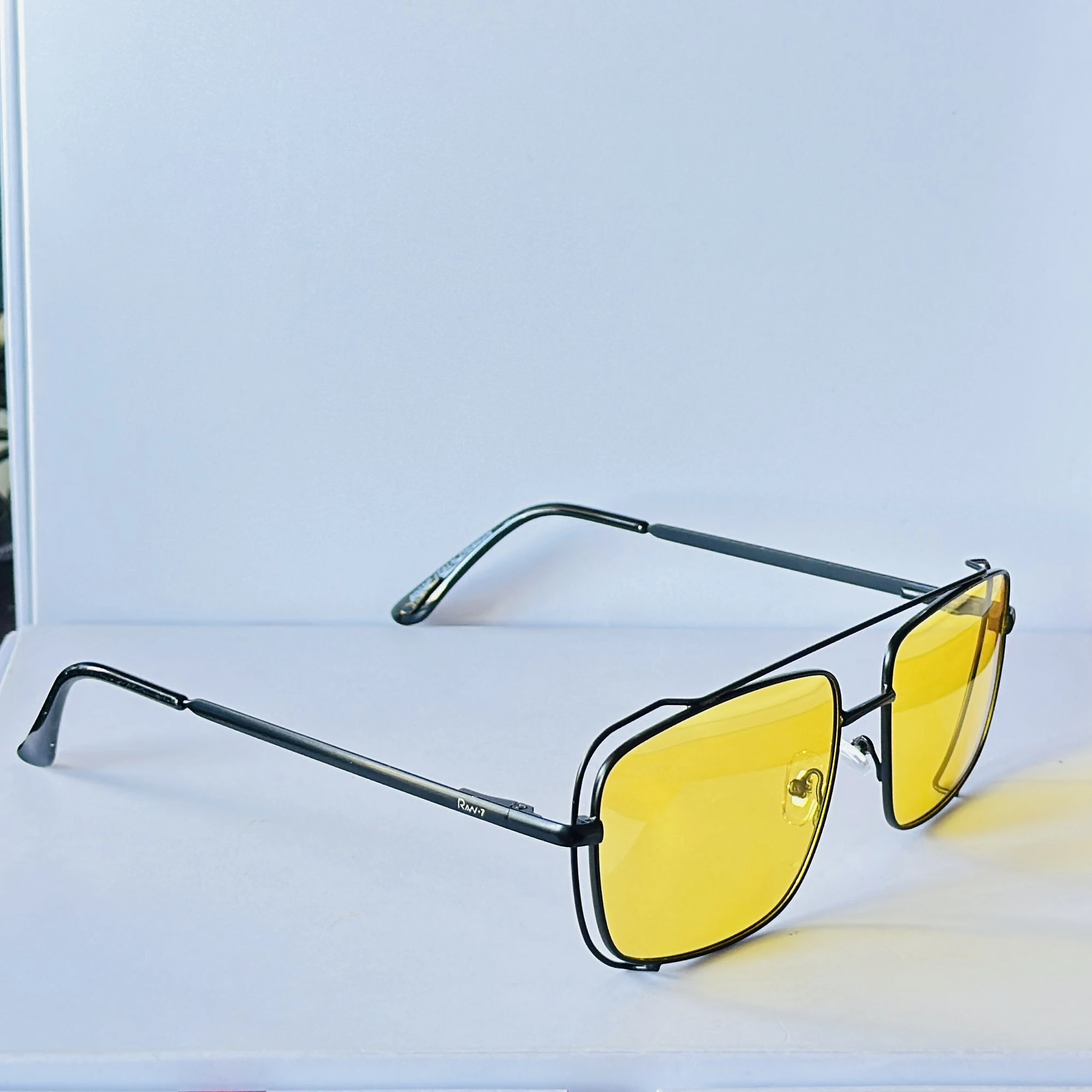 pair of unisex yellow lens square sunglasses featuring a metal frame.