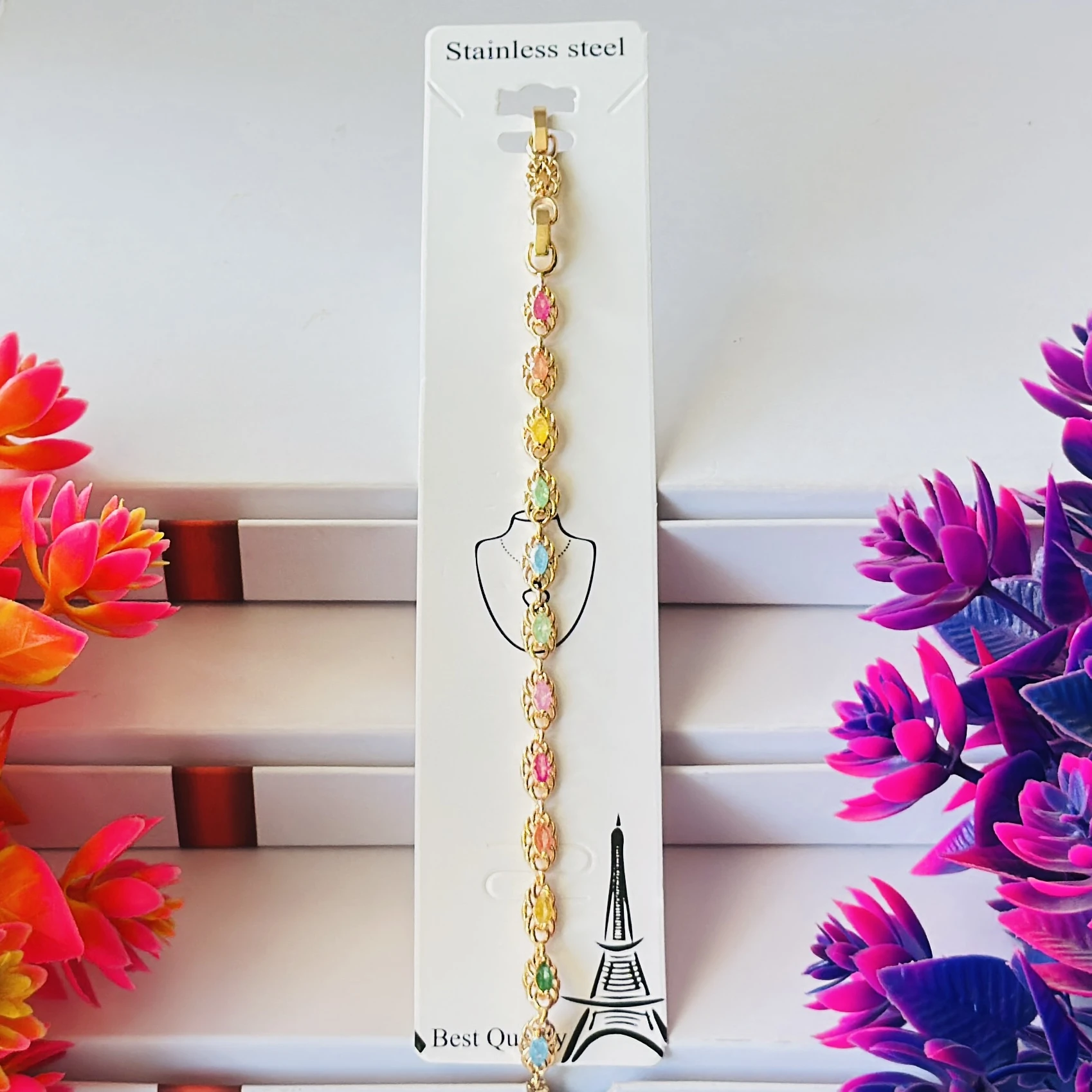 Gold plated chain bracelet with multicolor oval-shaped stones.