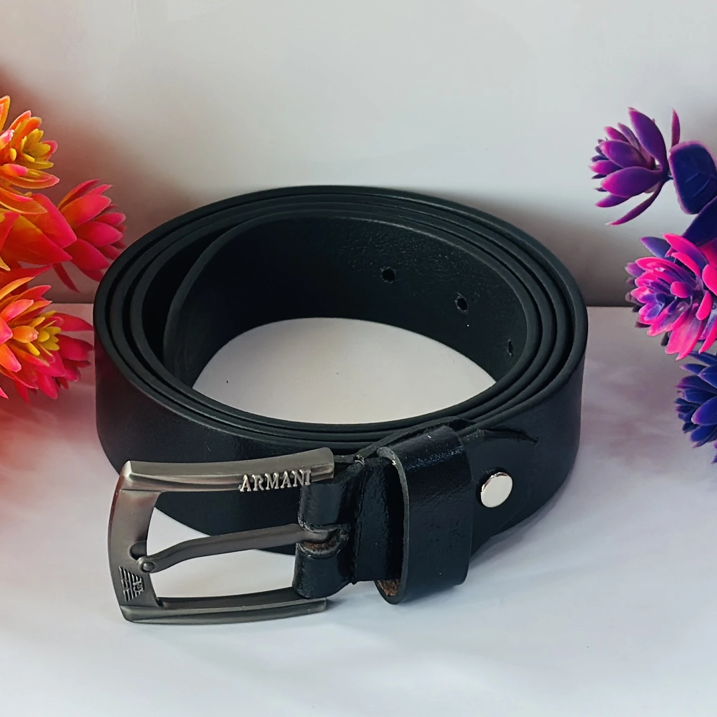 Black leather belt with a gunmetal buckle.