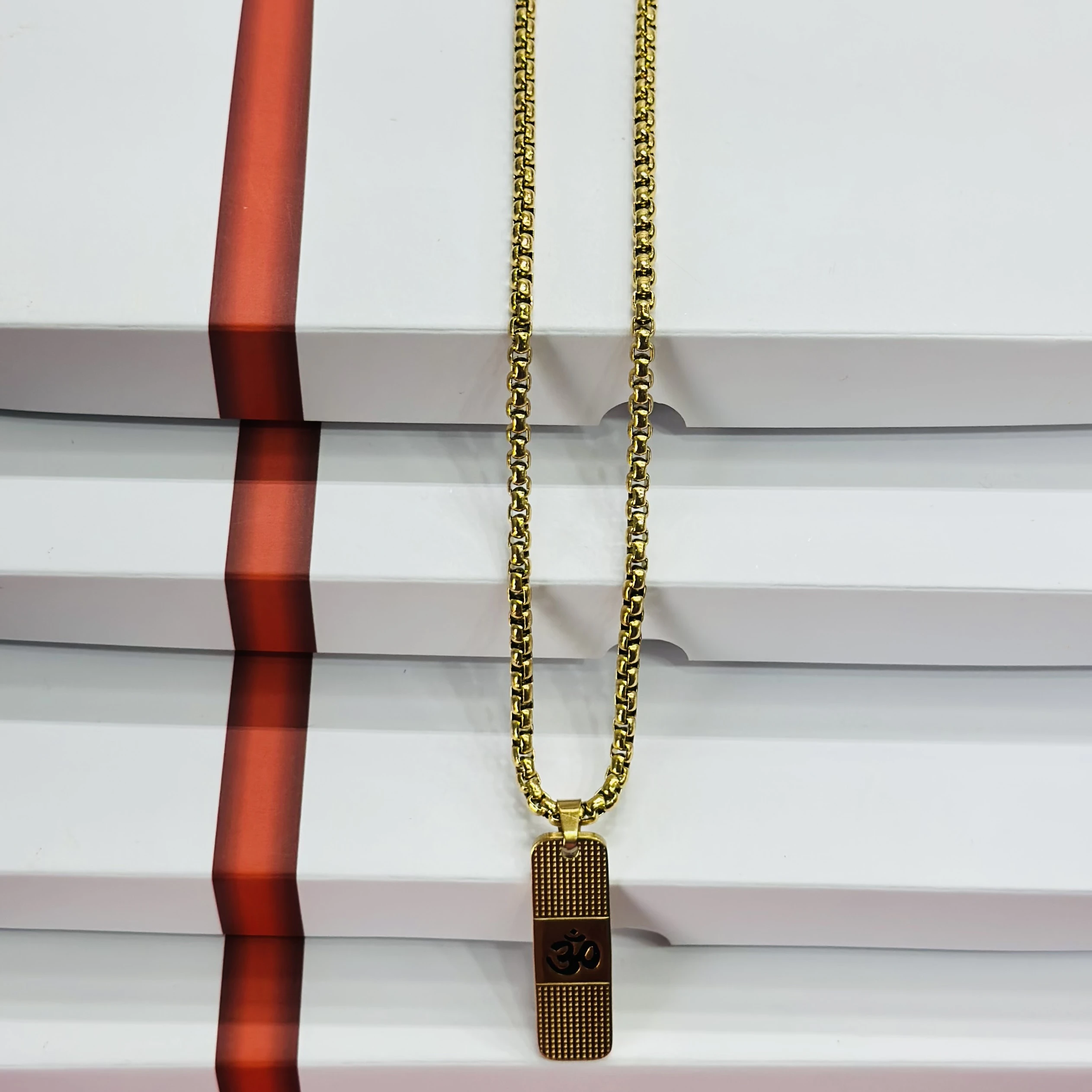 Gold plated pendant necklace featuring the sacred Hindu symbol "Om".