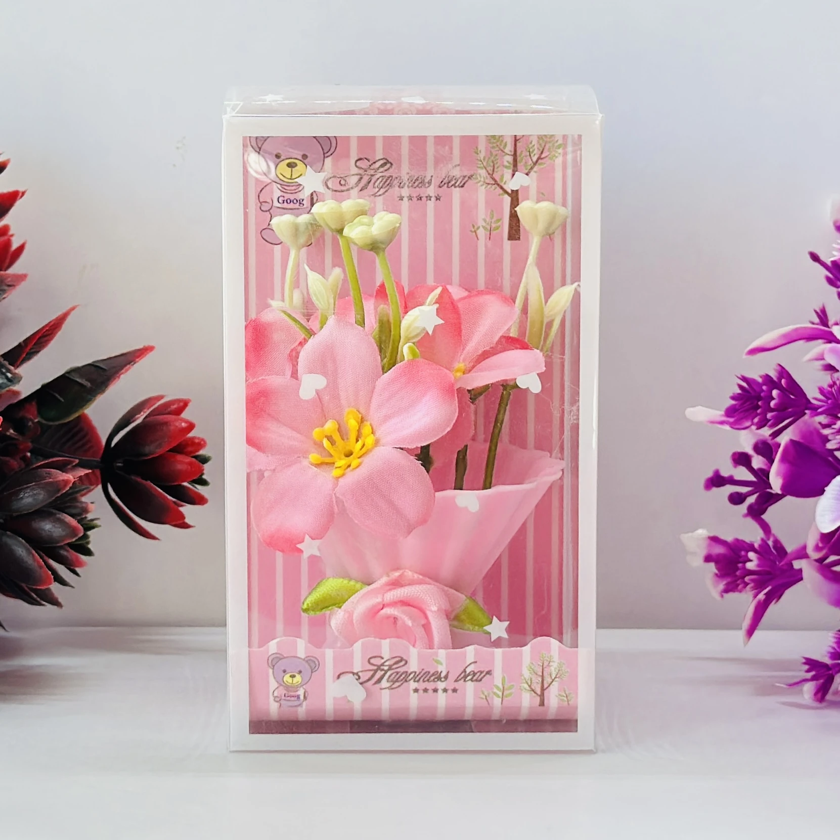 Set of artificial pink tulip flowers presented in a decorative gift box.
