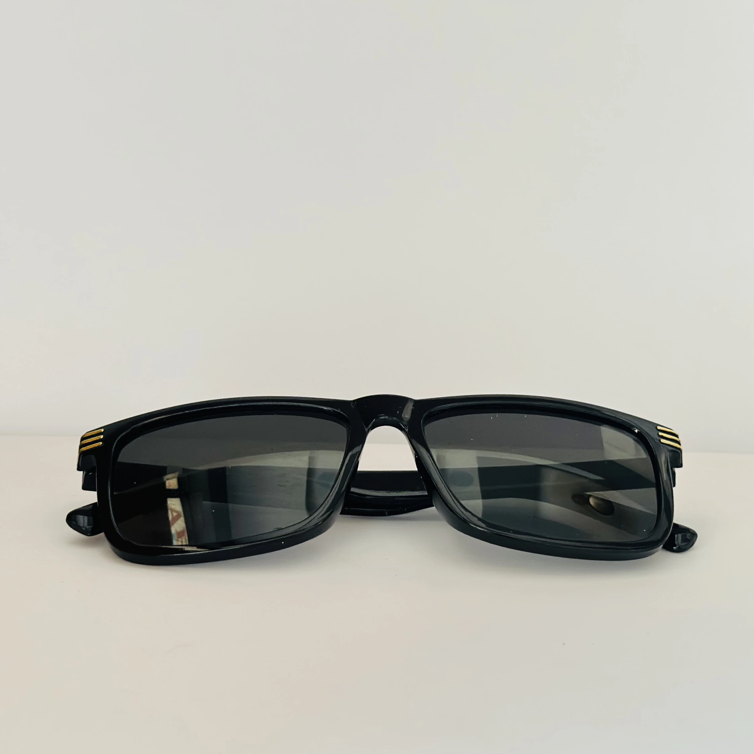 Saint Laurent SL 710 OPT eyeglasses with a black acetate frame and gold-toned details.