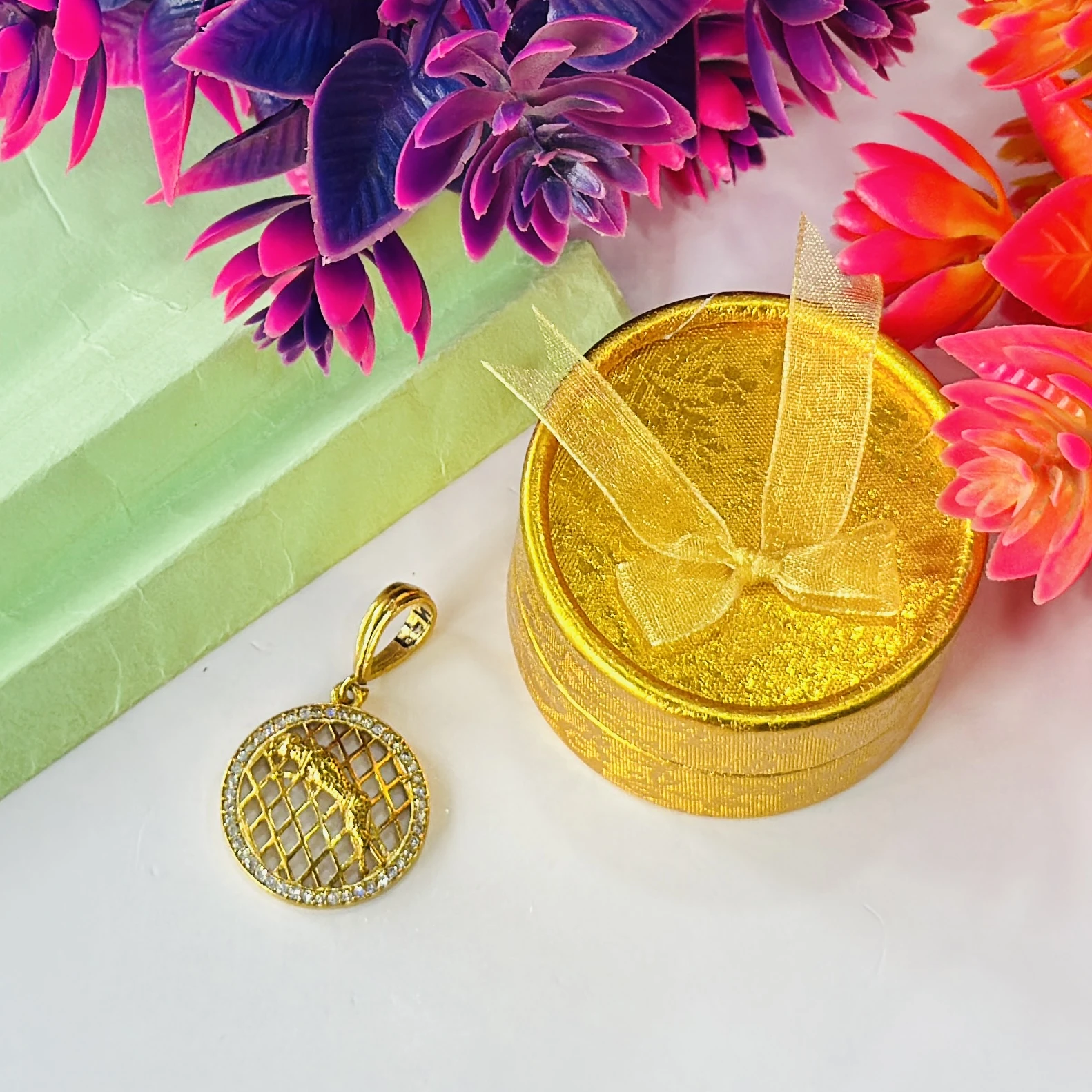 Gold plated jaguar pendant with a diamond texture background.