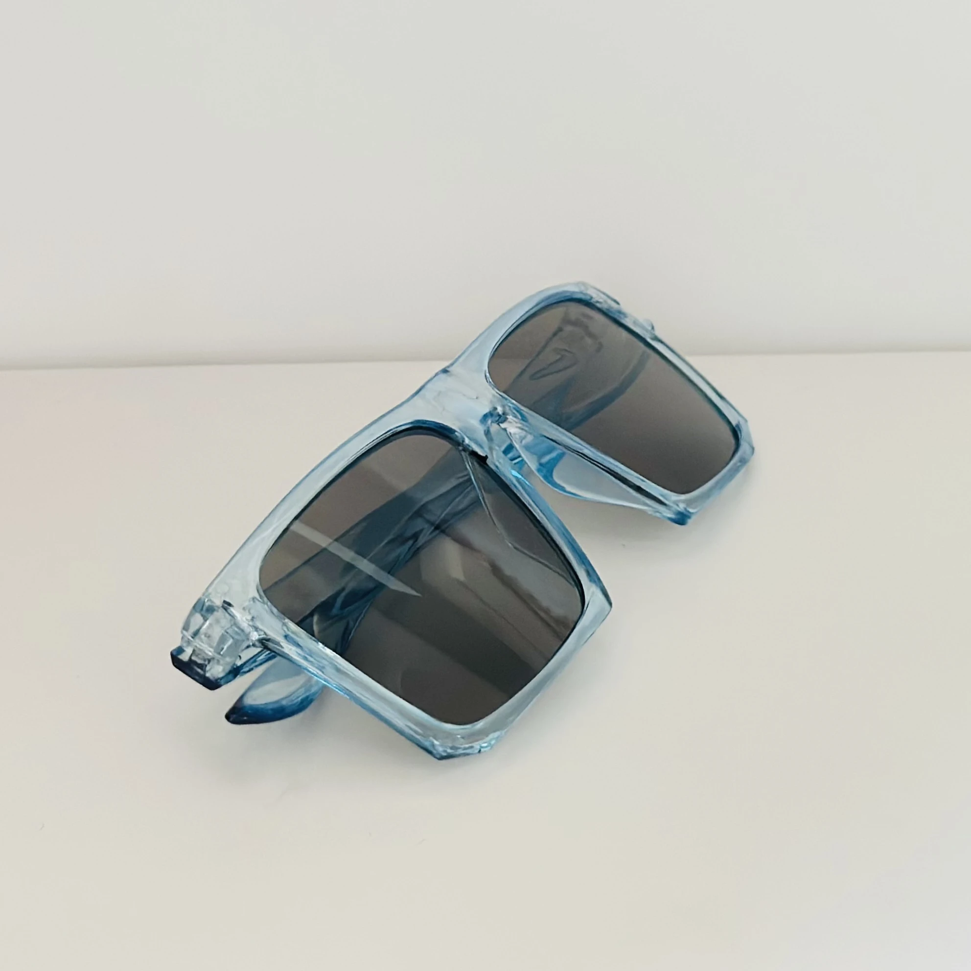 Voyage polarized sunglasses with a blue frame and black lenses.