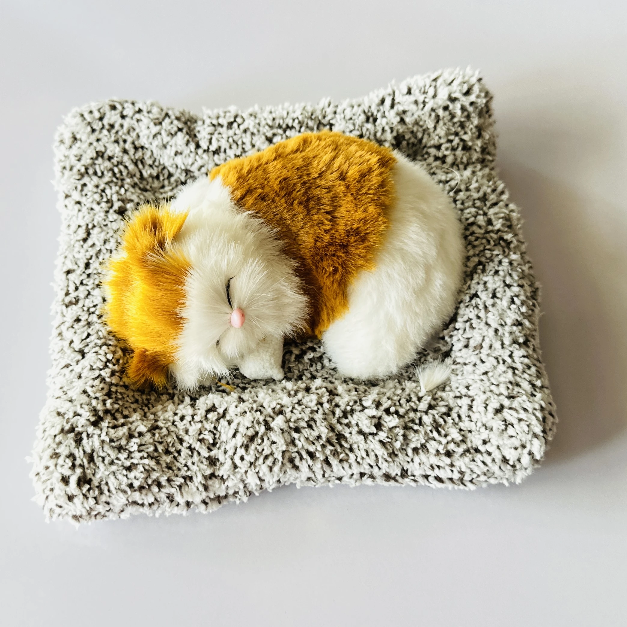 plush toy depicting a sleeping cat