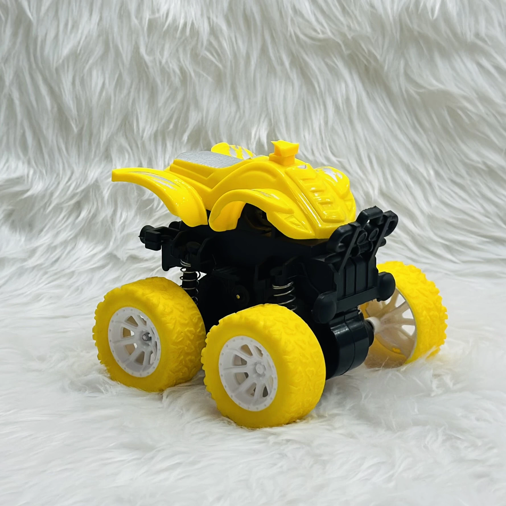 yellow friction-powered monster truck toy.