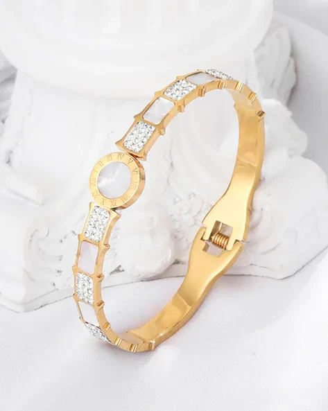 stainless steel gold-plated mother of pearl Roman numerals AD studded bracelet.