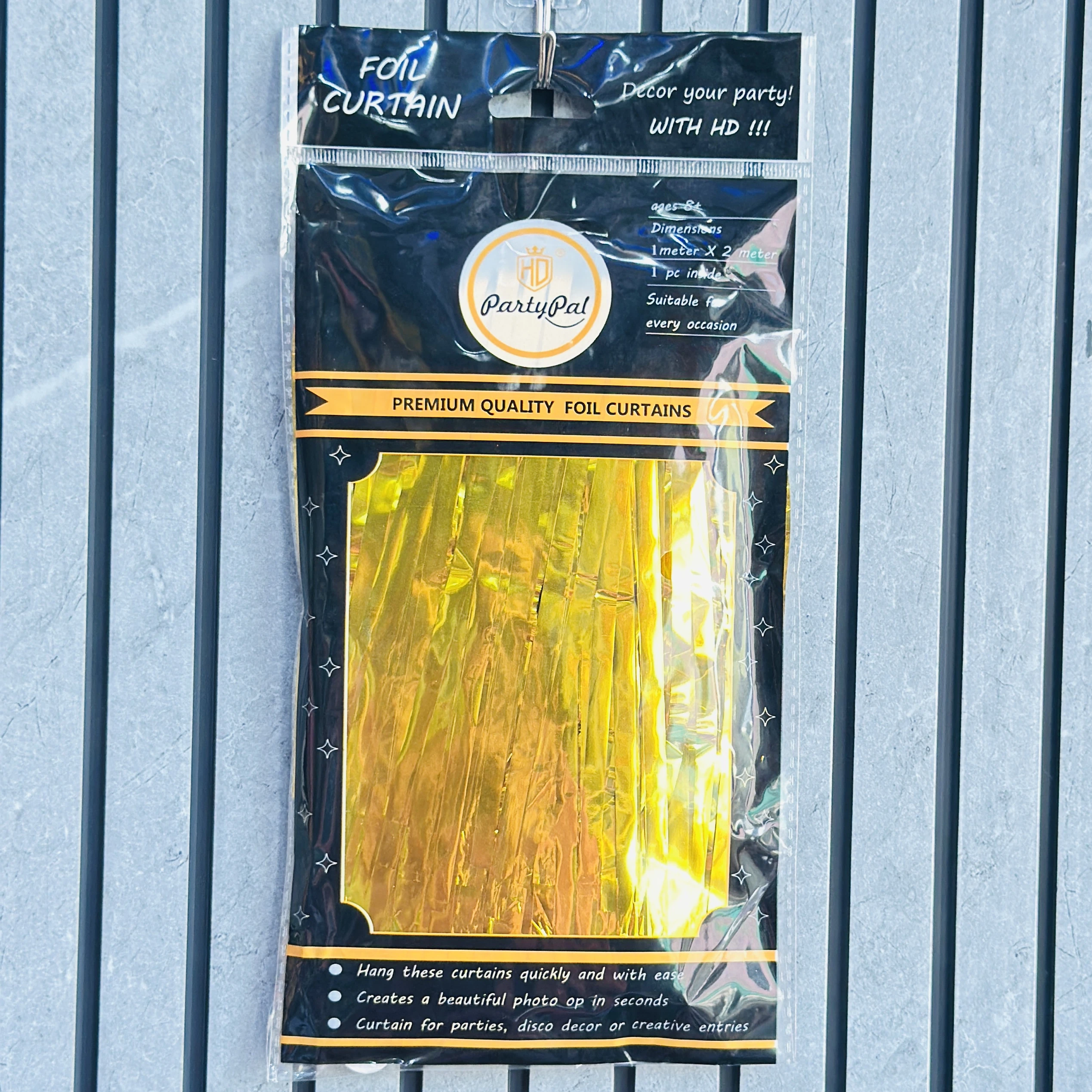 PartyPal gold foil fringe curtain backdrop for party decorations.