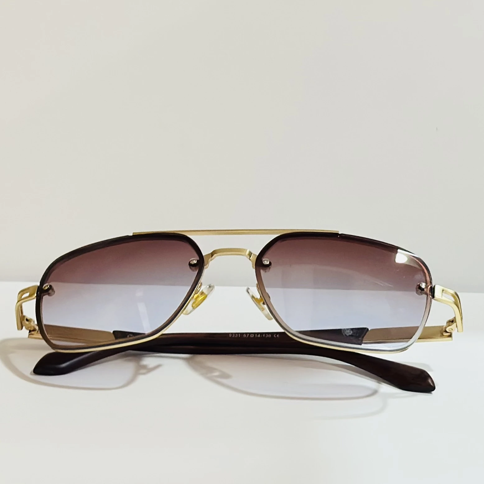 pair of Maybach square gradient sunglasses with a gold-tone frame.