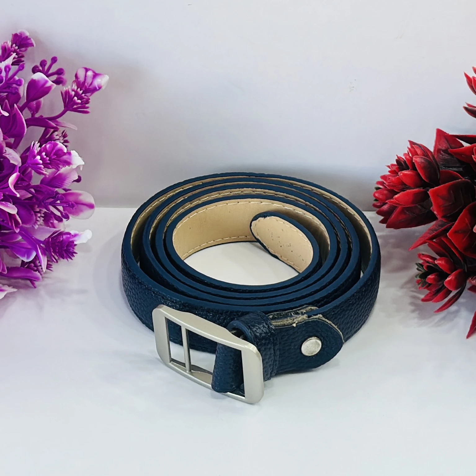 Blue leather belt with a silver-tone buckle.