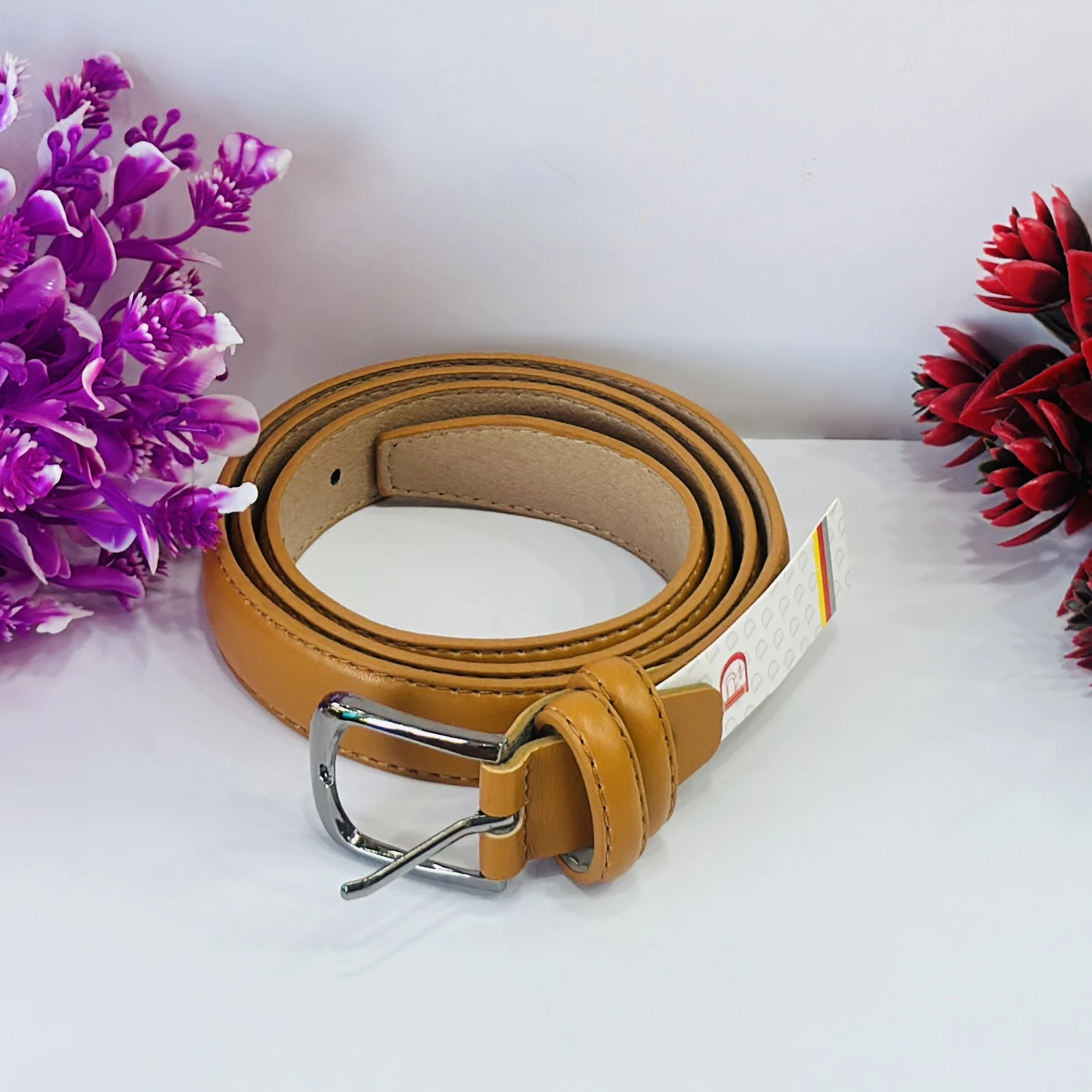Tan or ocher-colored leather waist belt
