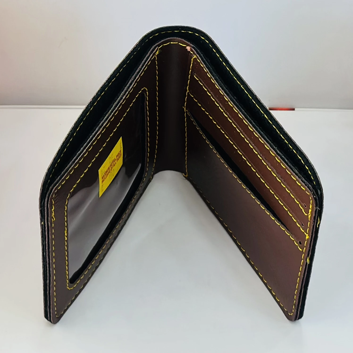 Crusset men's brown bi-fold wallet made of PU material.