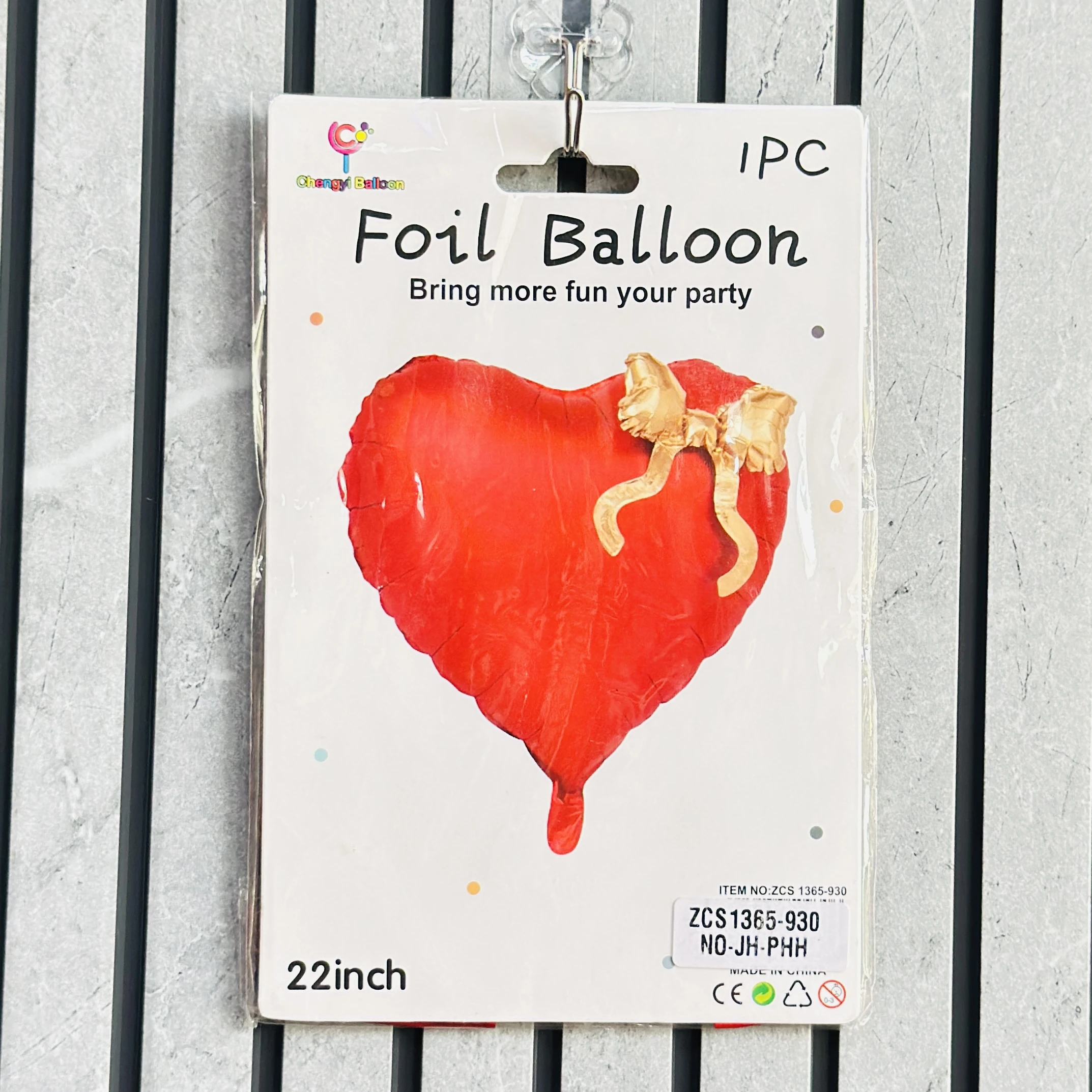 22-inch Chengyi Balloon red heart-shaped foil balloon with an attached gold bow.