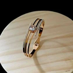 elegant gold-plated crystal-studded cuff bracelet