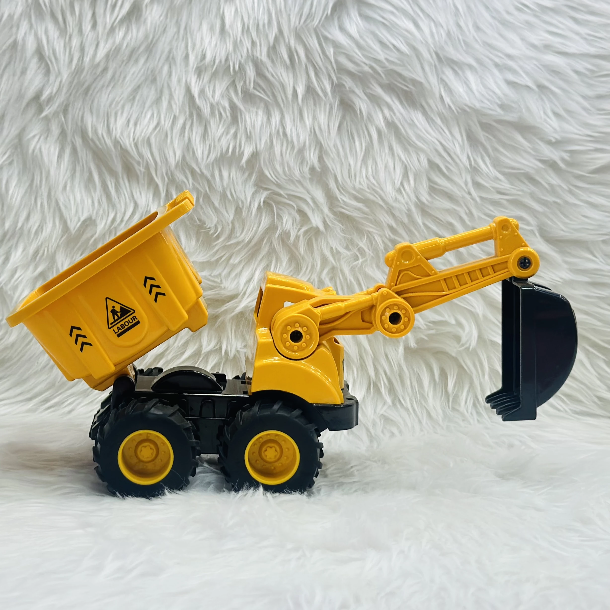 Yellow plastic toy construction vehicle, specifically a 2-in-1 friction-powered dumper and excavator truck.