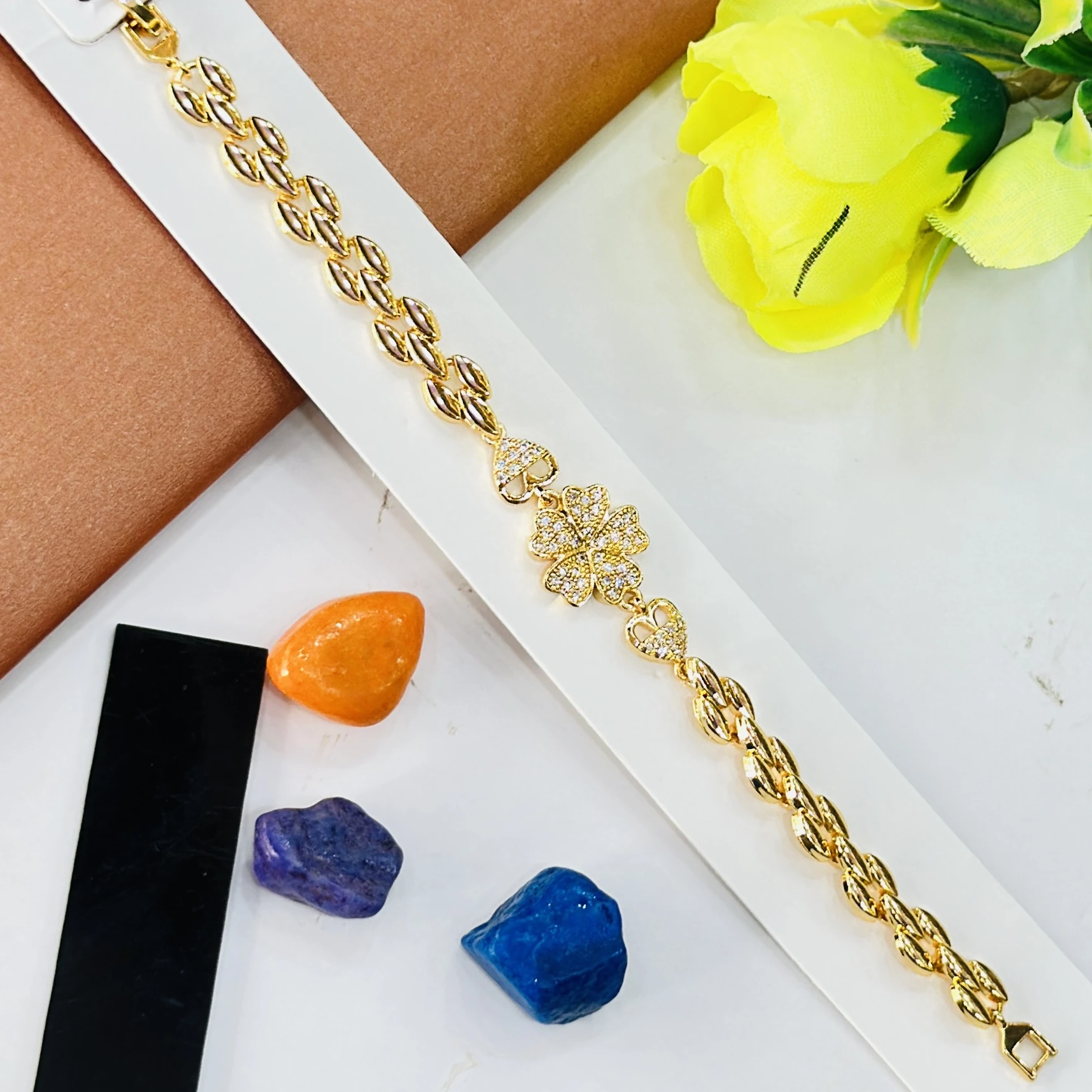 Gold plated bracelet with a central clover design