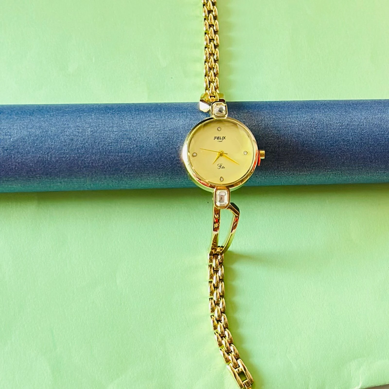 analog watch with a white dial and a rose gold metal strap