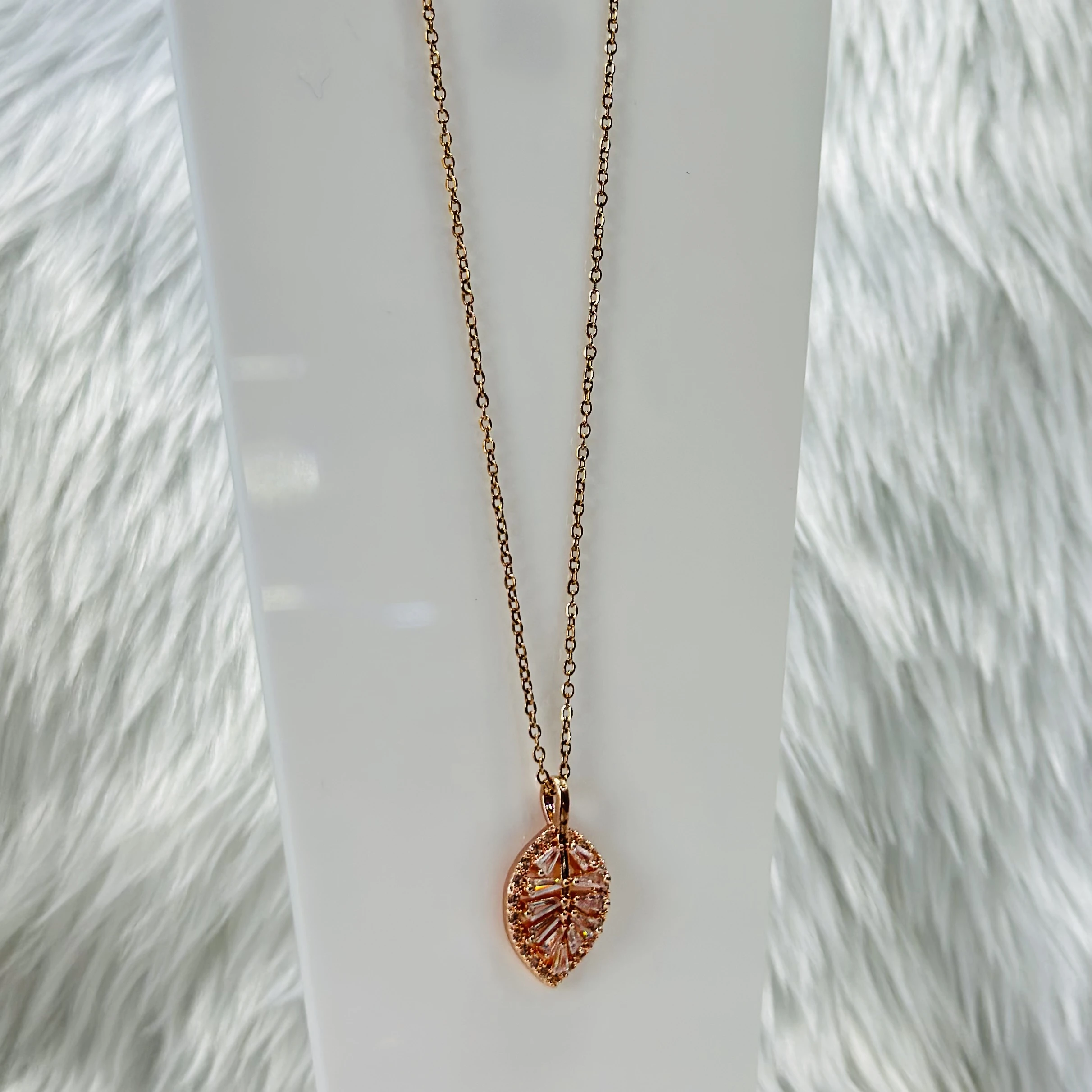 Rose gold palm leaf necklace with diamond accents, crafted from stainless steel.