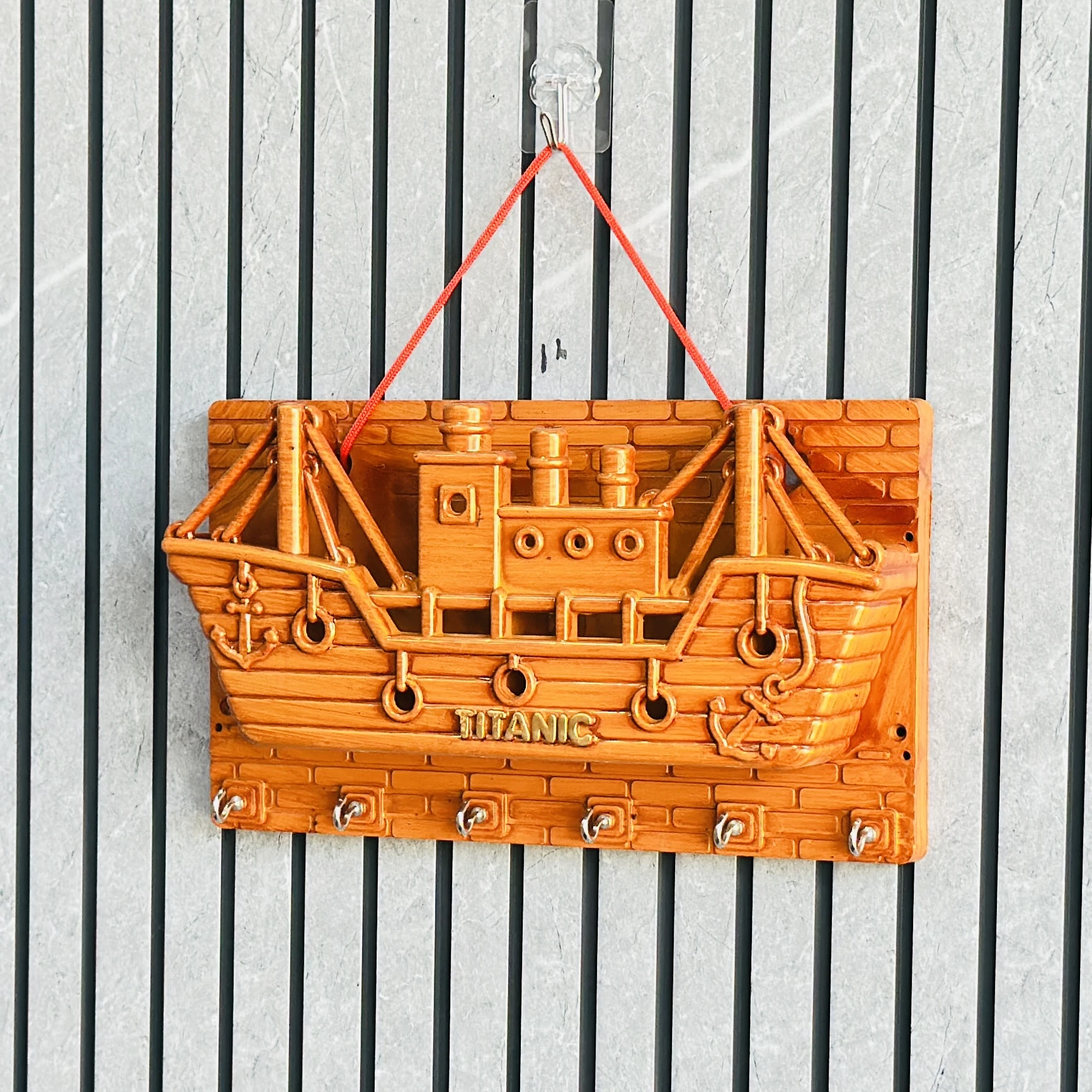 wooden wall-mounted key holder (BRYTZG )shaped like a ship labeled "TITANIC".