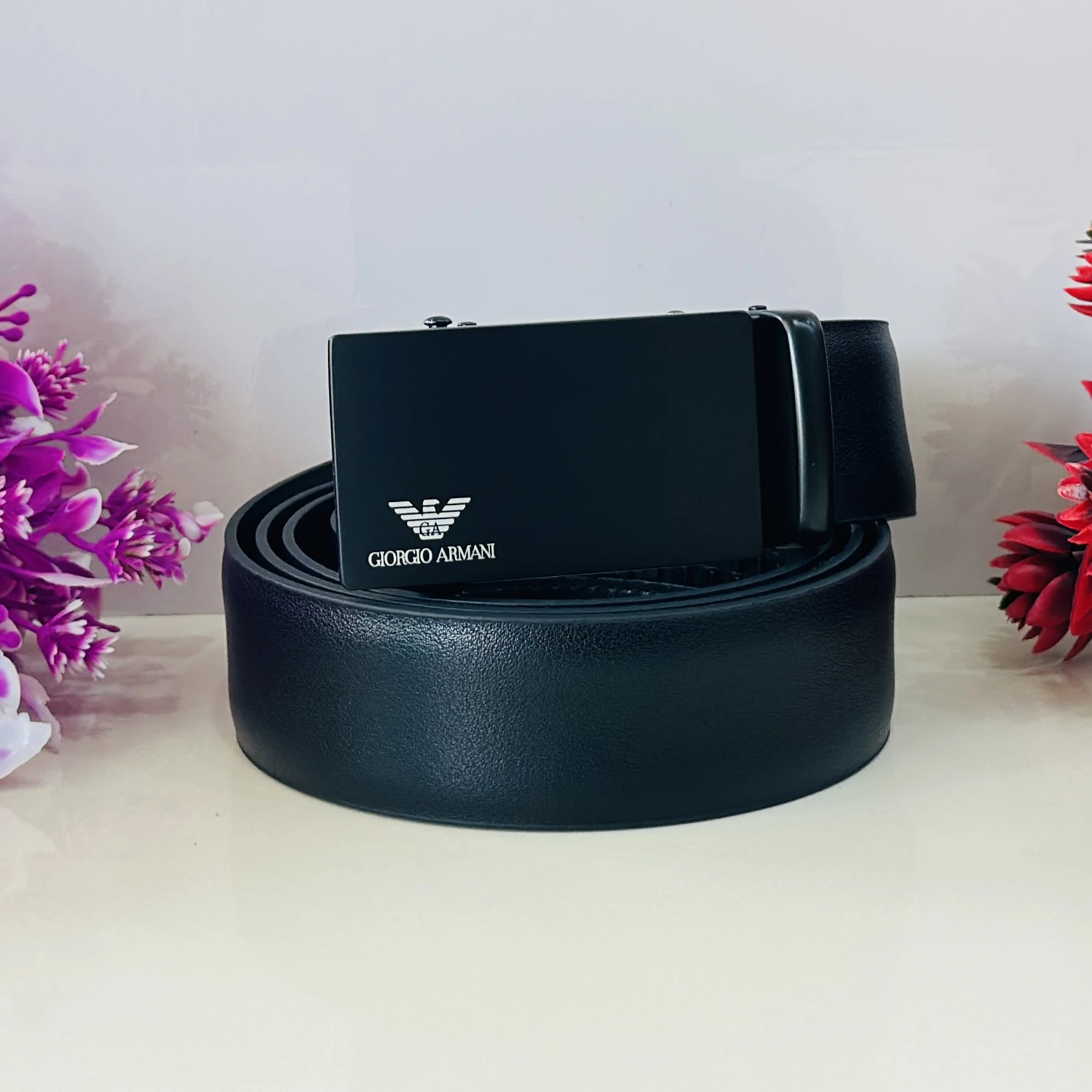 Emporio Armani black leather belt with a logo plaque buckle.