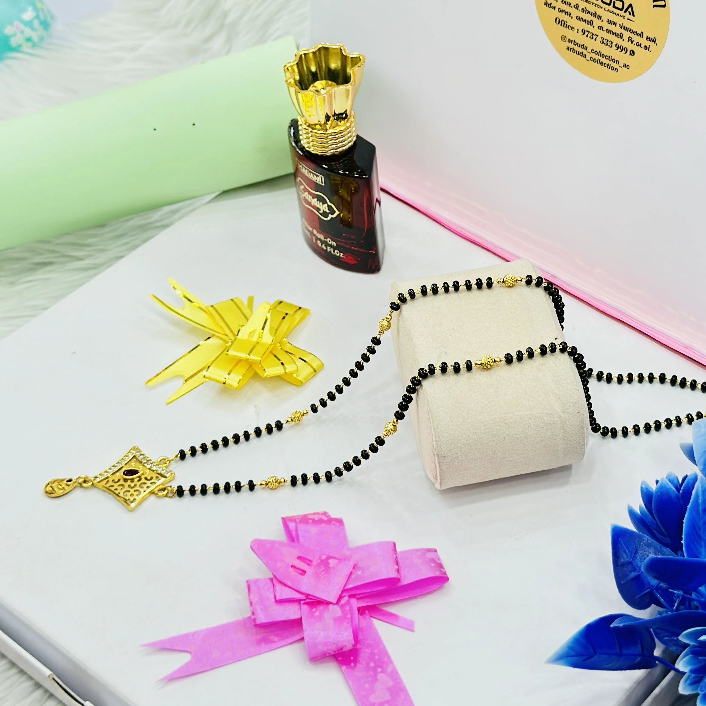 Gold plated mangalsutra features a designer pendant and black beaded chain.