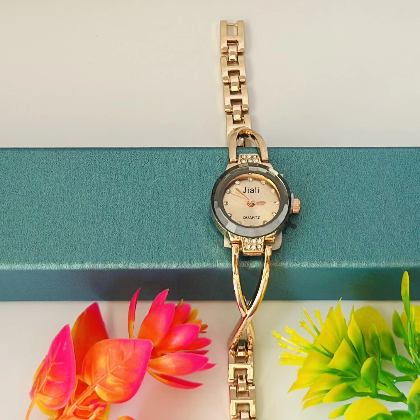 Rose gold-toned women's bracelet watch with a crystal-accented dial.