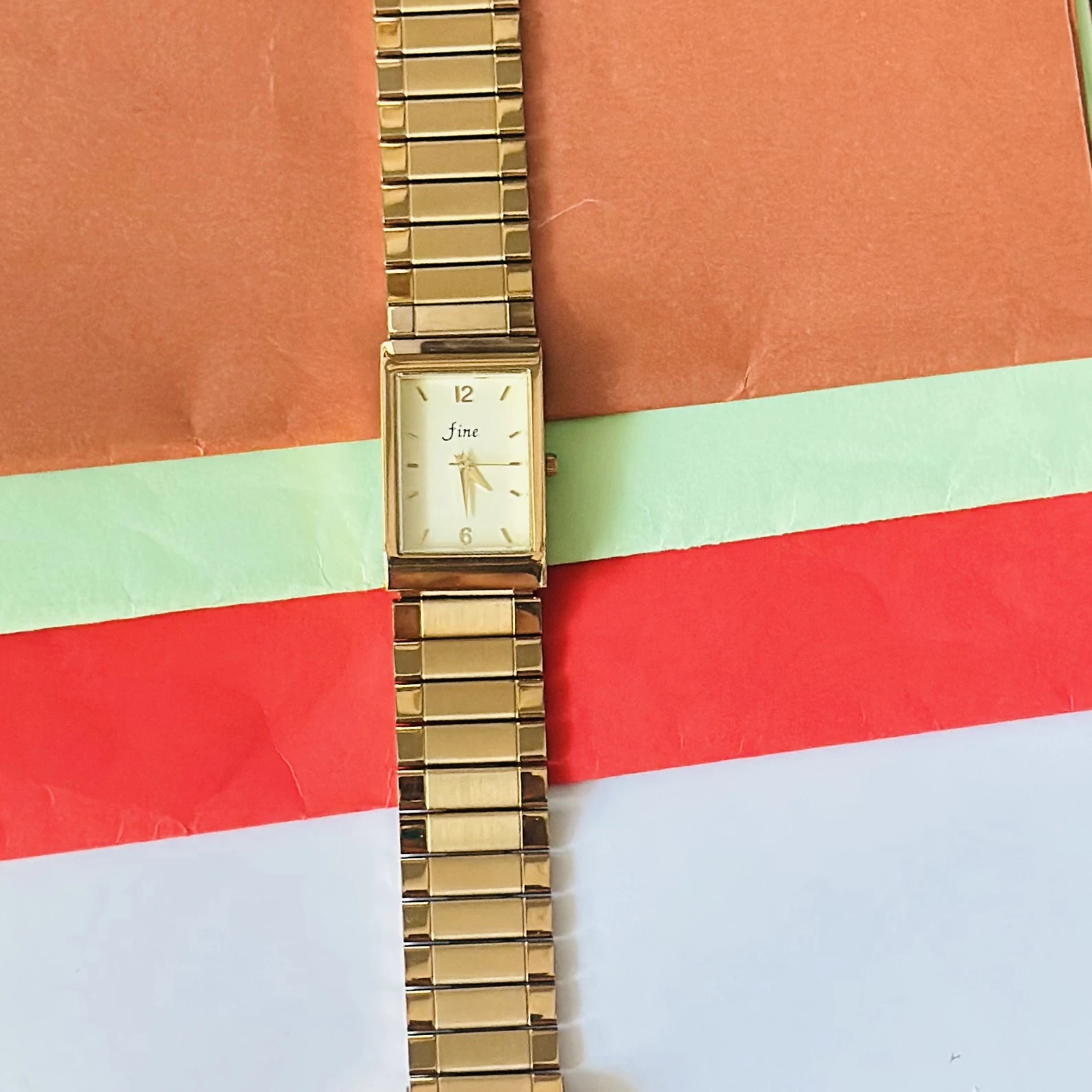 Gold -tone analog quartz watch with a metal strap.