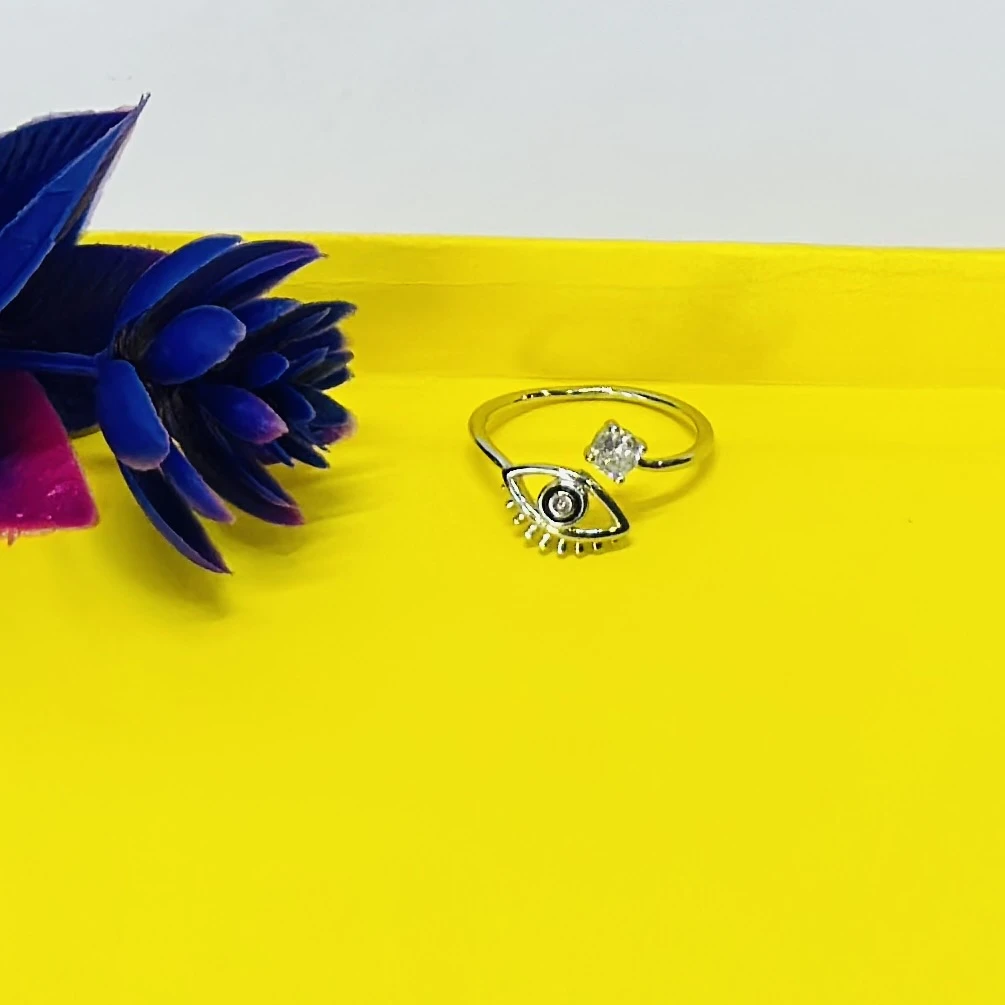 an adjustable sterling silver "evil eye" ring with a clear cubic zirconia stone.