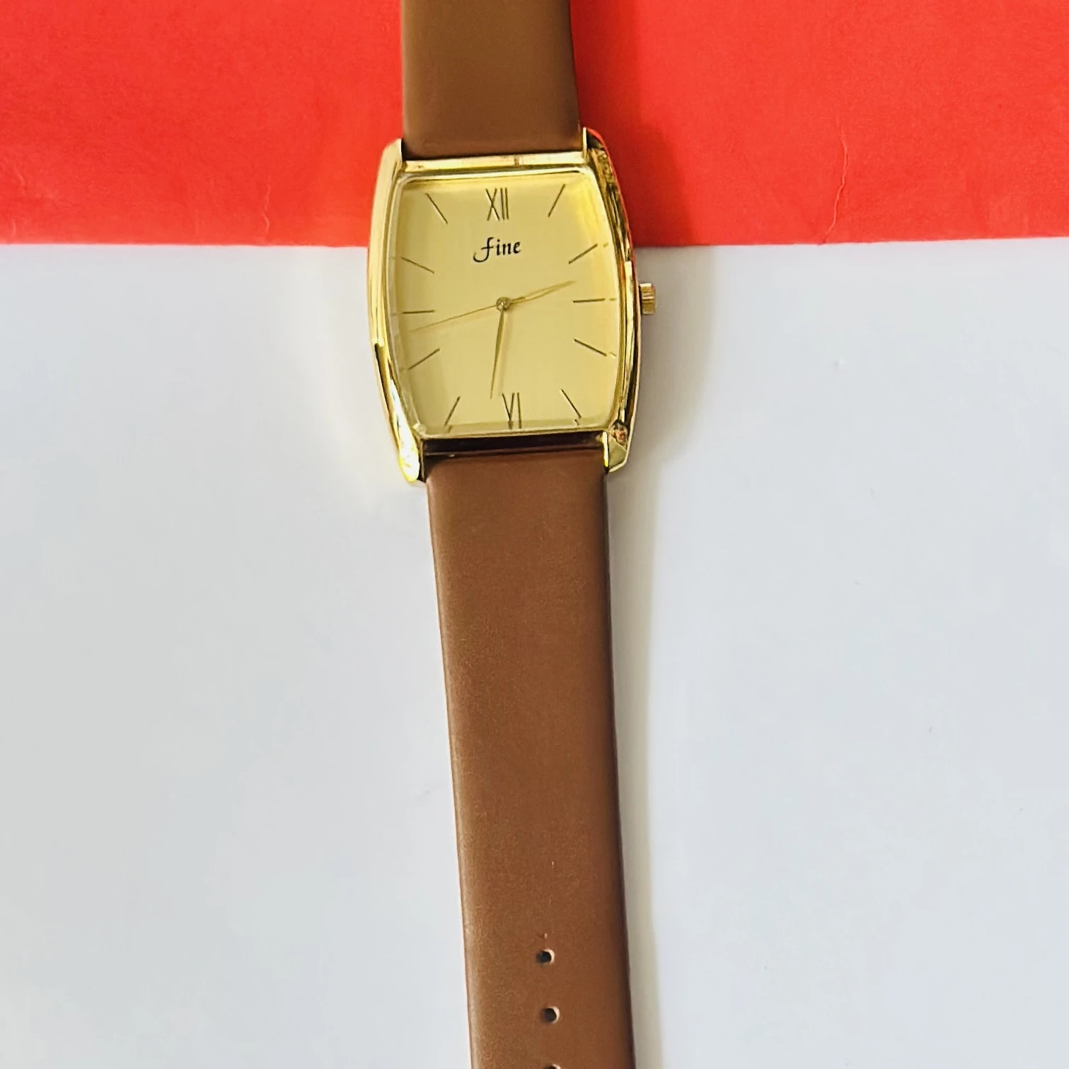 Gold toned GEDI women's quartz watch with a brown leather strap.