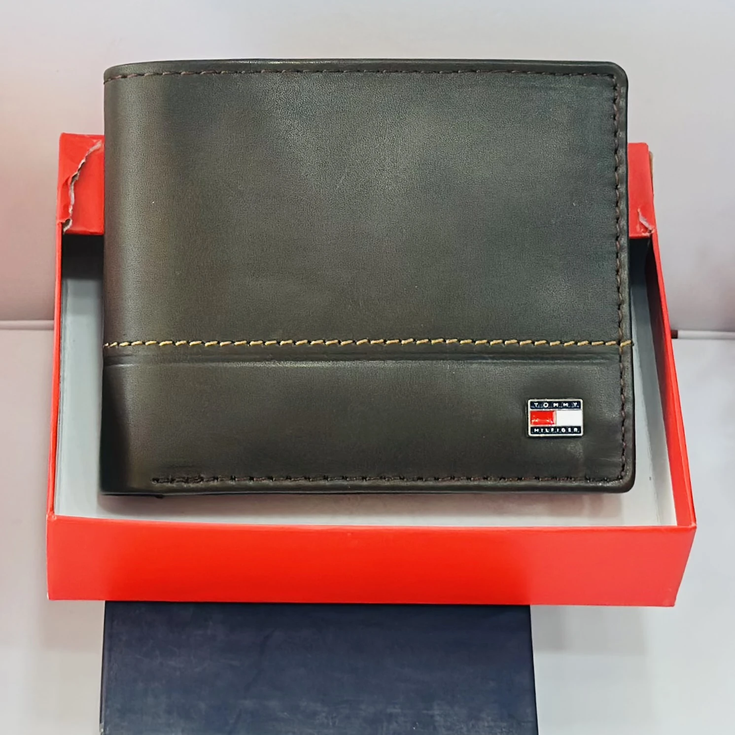 Tommy Hilfiger men's genuine leather bi-fold wallet.
