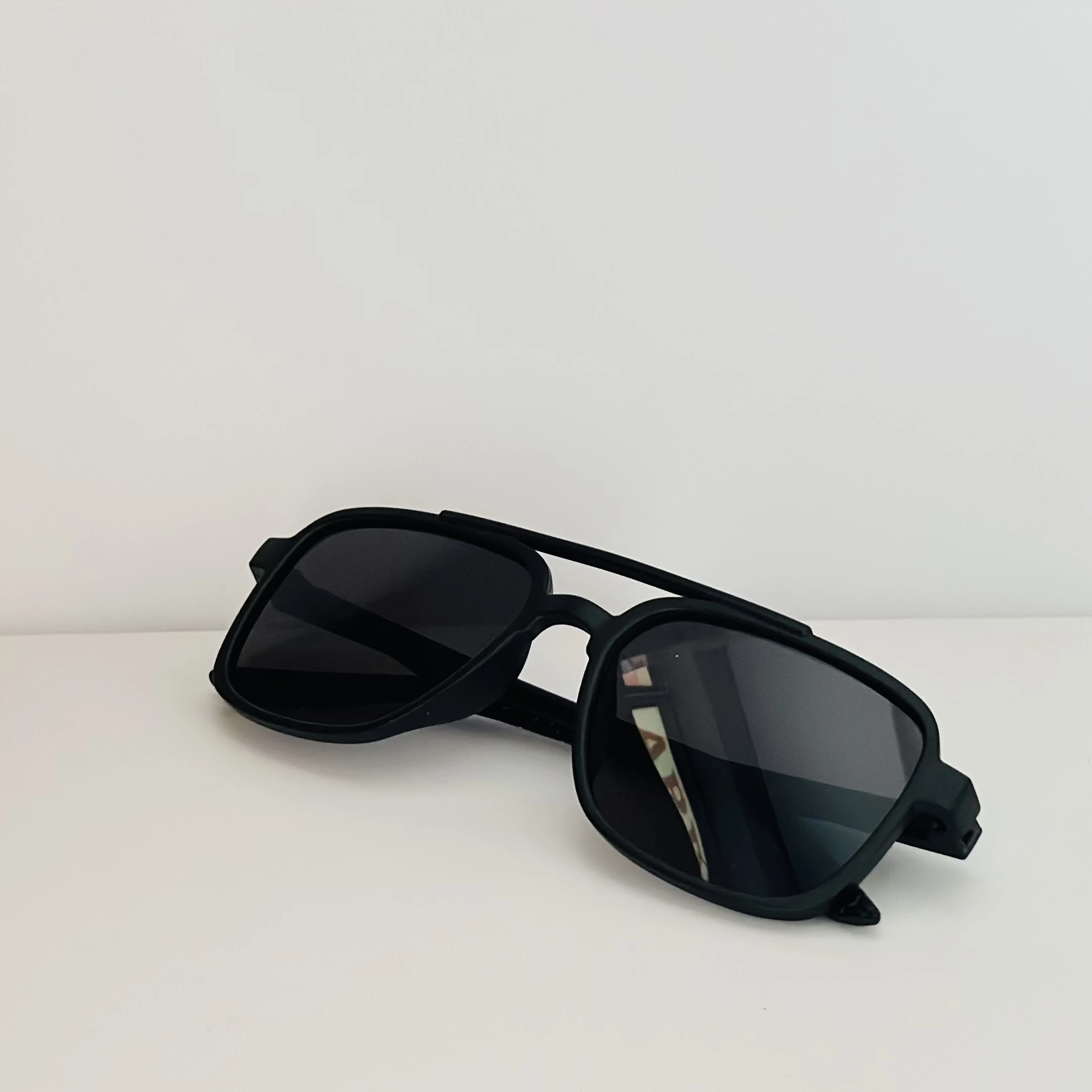 Vincent Chase black round sunglasses.