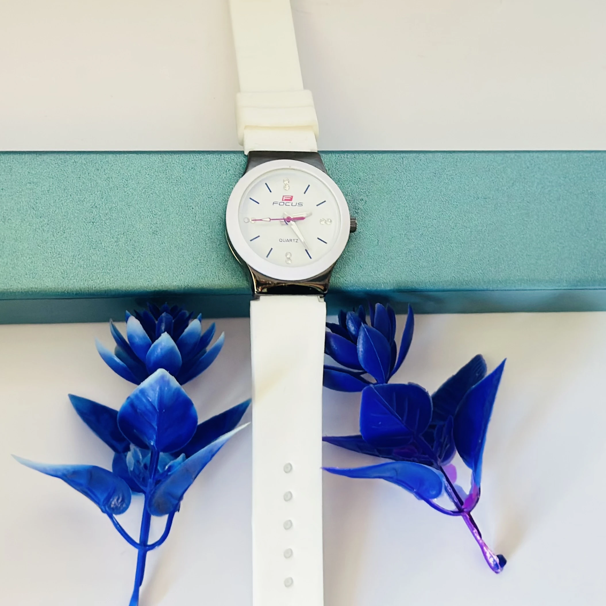 White Focus quartz analog watch for women with a white leather strap.
