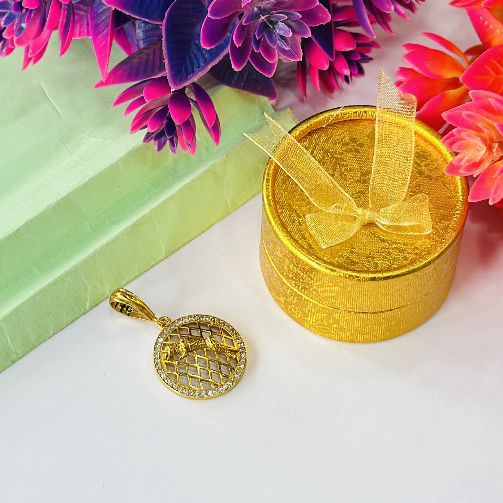 Gold plated jaguar pendant with a diamond texture background.