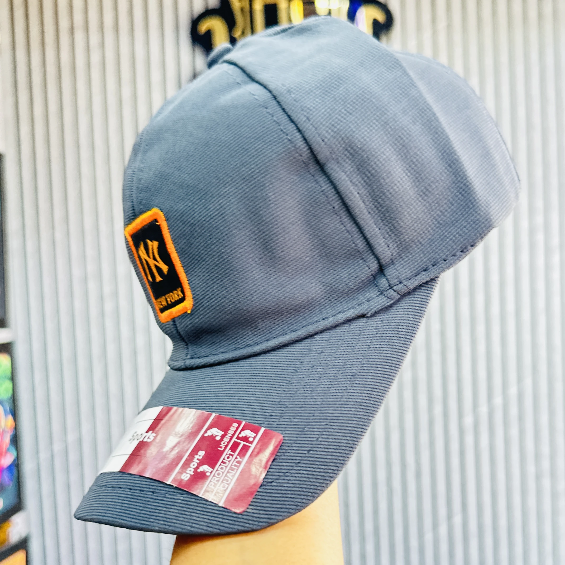 Gray baseball cap features the New York Yankees logo.