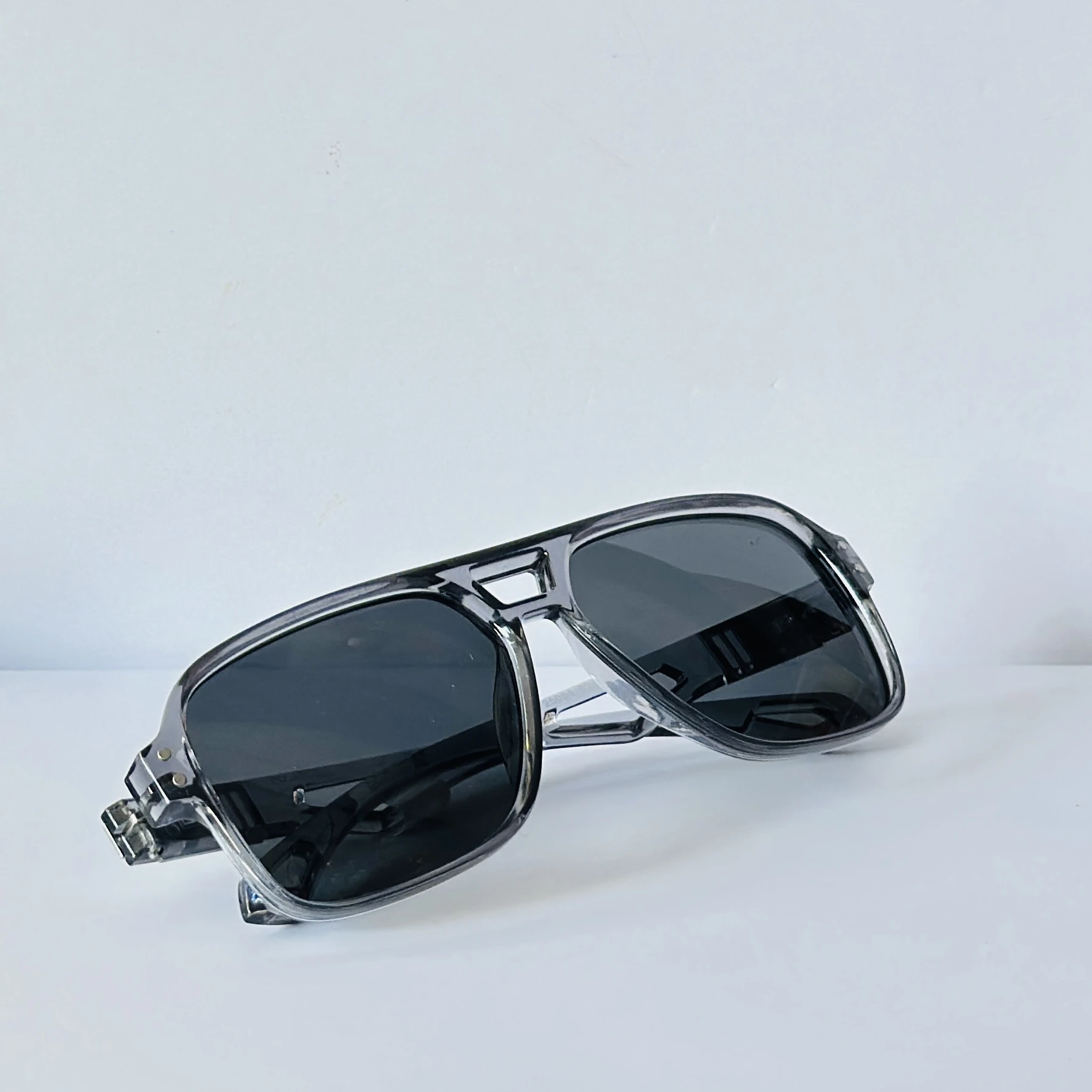 sunglasses in a transparent grey frame color.