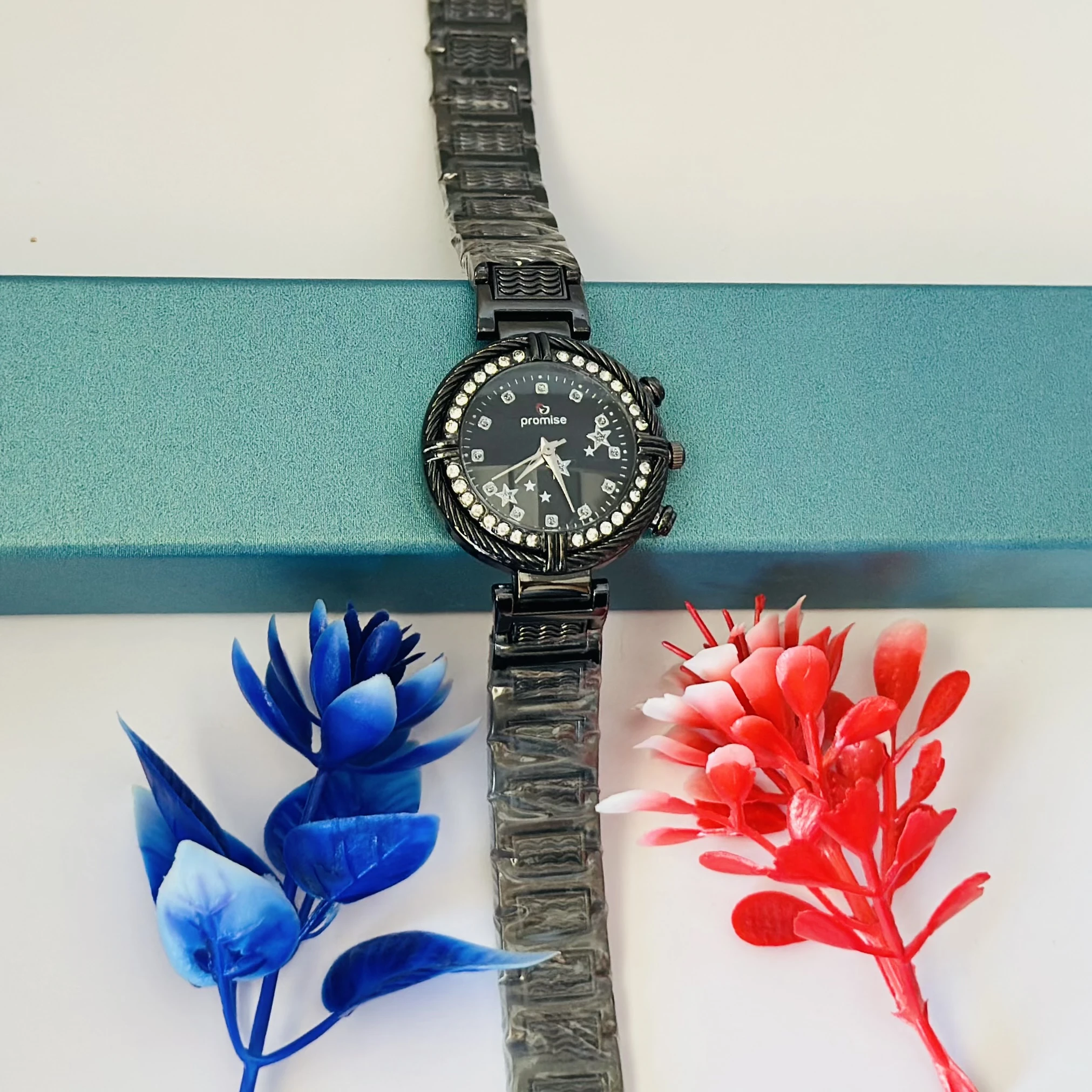 Ladies fashion watch with a black metal strap.