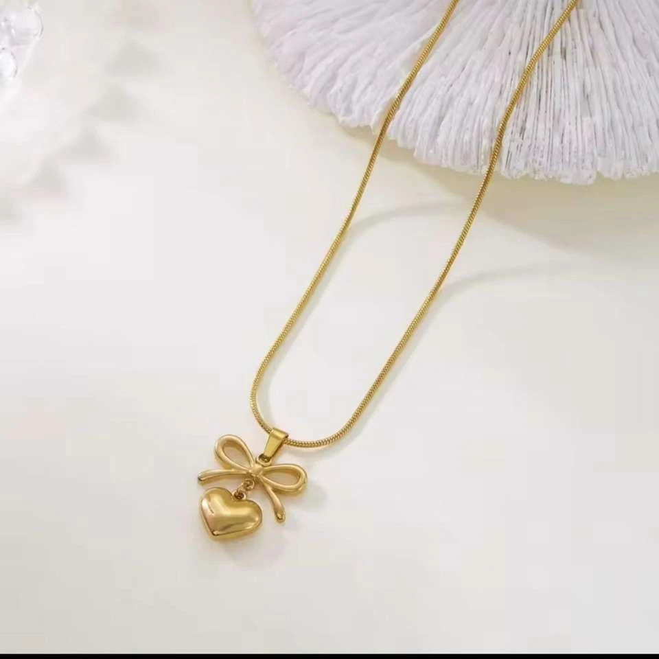 Lumora Forever Gleaming necklace features a heart and bow pendant