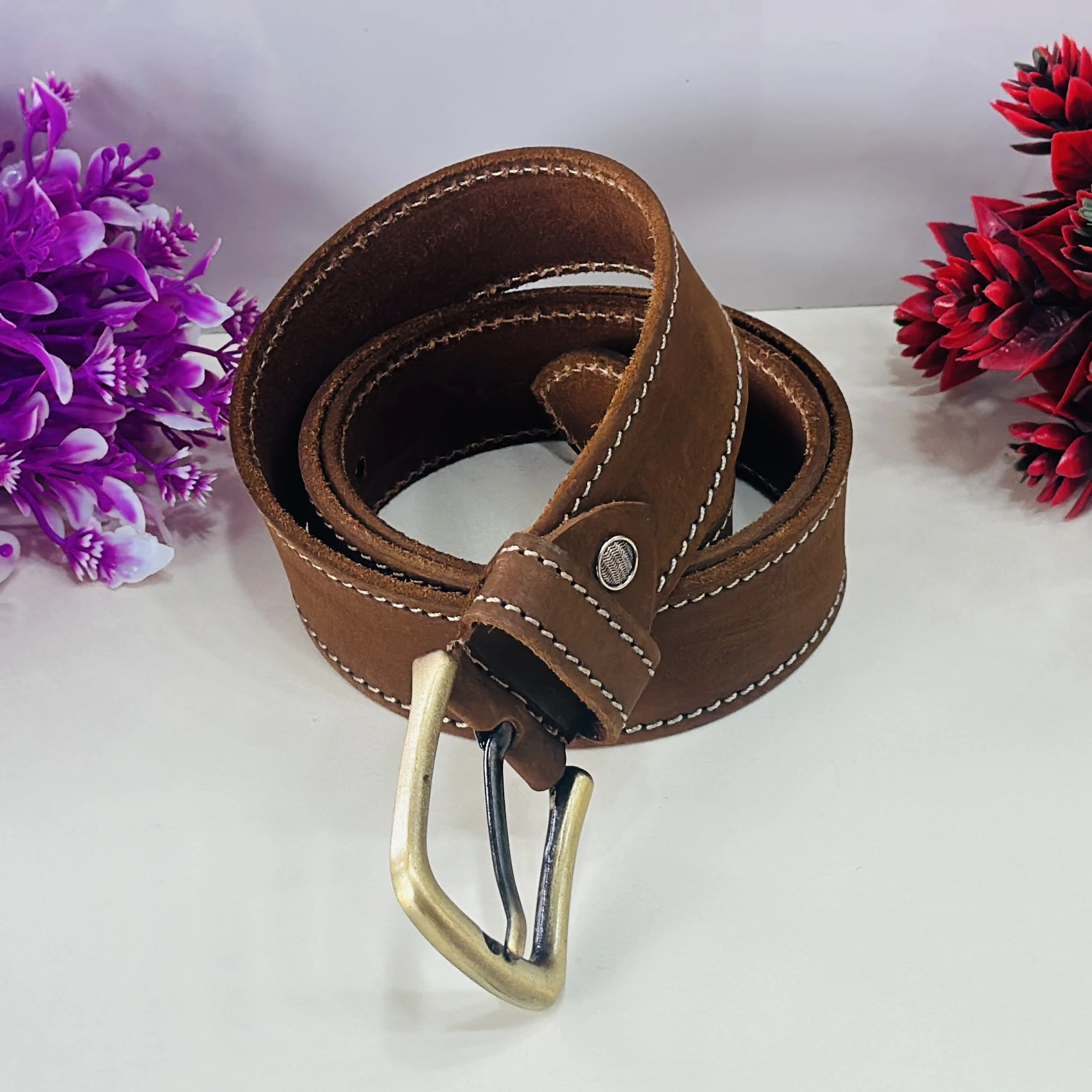 Brown genuine leather belt with a pin buckle closure.