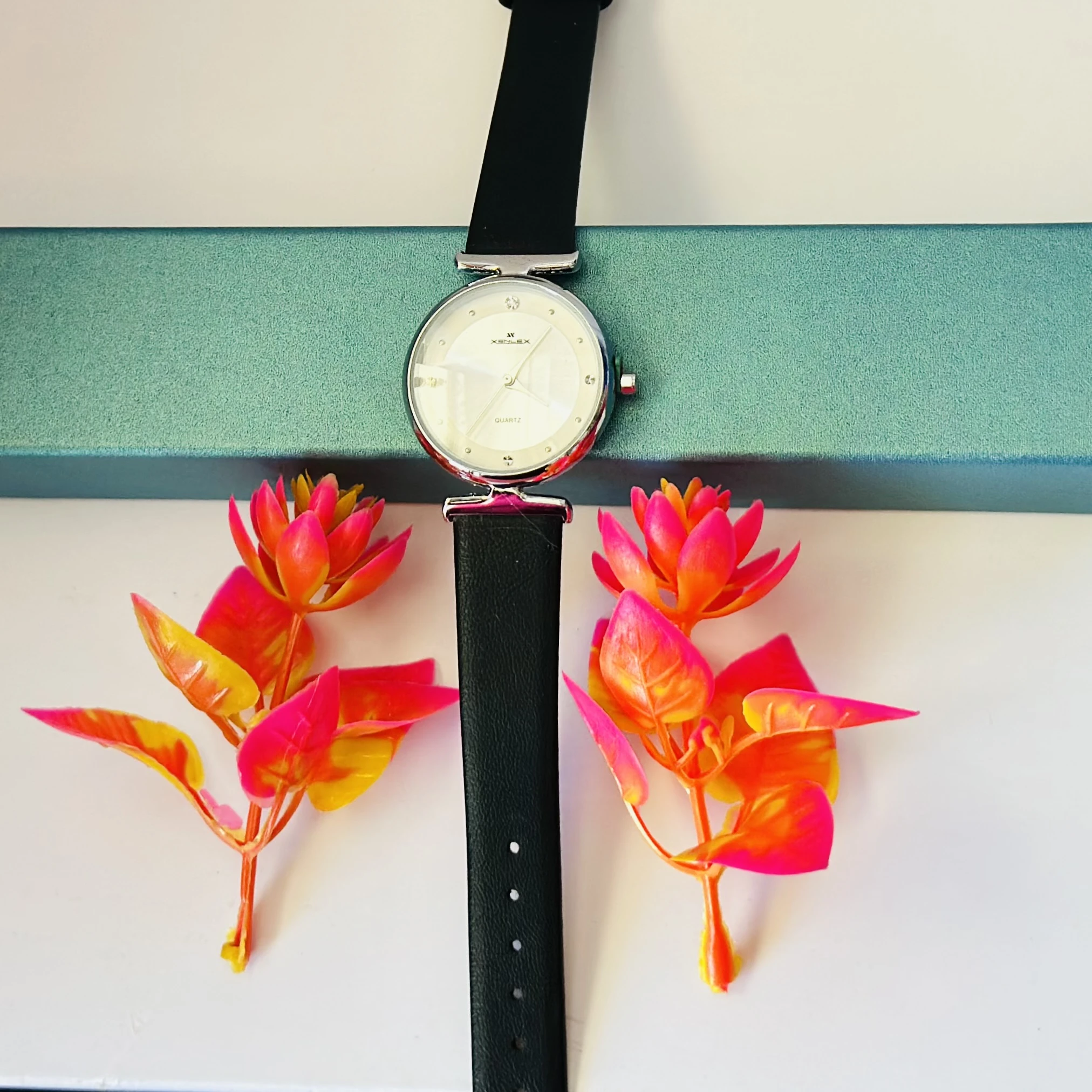 Analogue watch for women with a black leather strap.