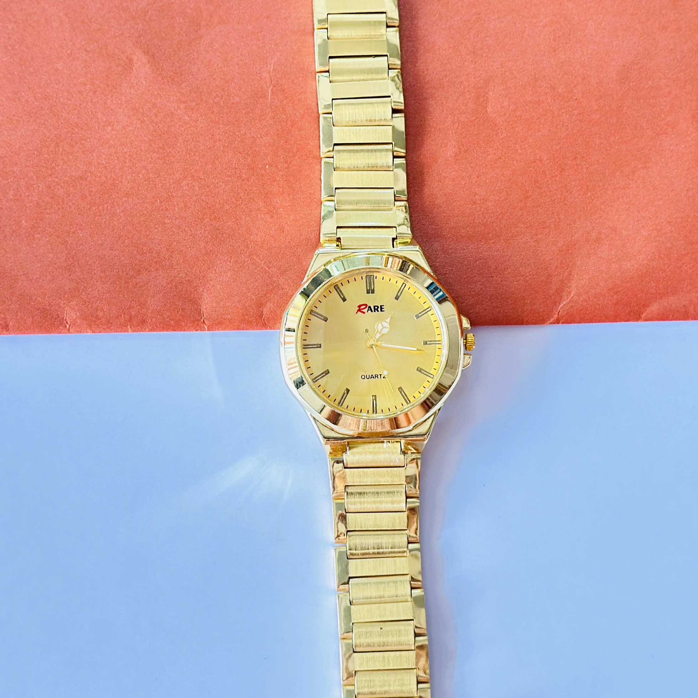 Gold coloured analogue watch