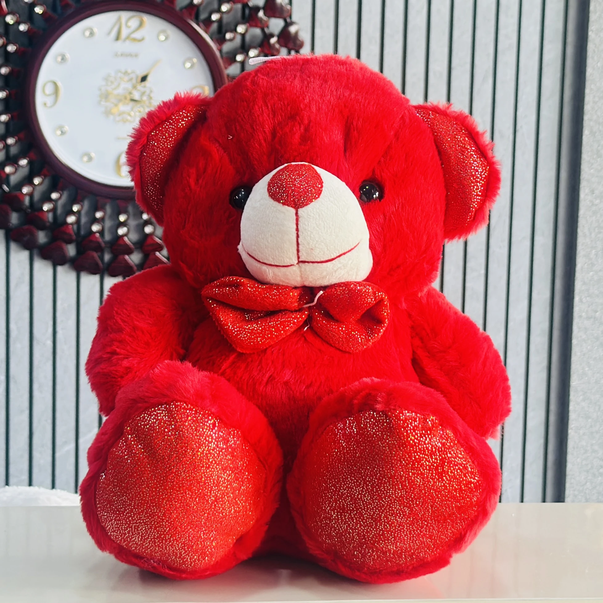 Red plush teddy bear, a type of soft toy.